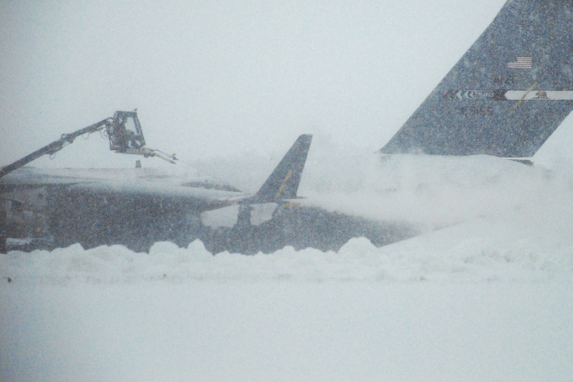 Team Dover maintenance crews work to deice a C-17 Globemaster during the nor'easter March 2. According to the 436th Operations Support Squadron Weather Flight, from the time the snow started falling at about 4:00 p.m. March 1, until it stopped at about 3:00 p.m. March 2, a total of 10.3 inches of snow fell. (U.S. Air Force Photo/2nd Lt. Brian Maguire)