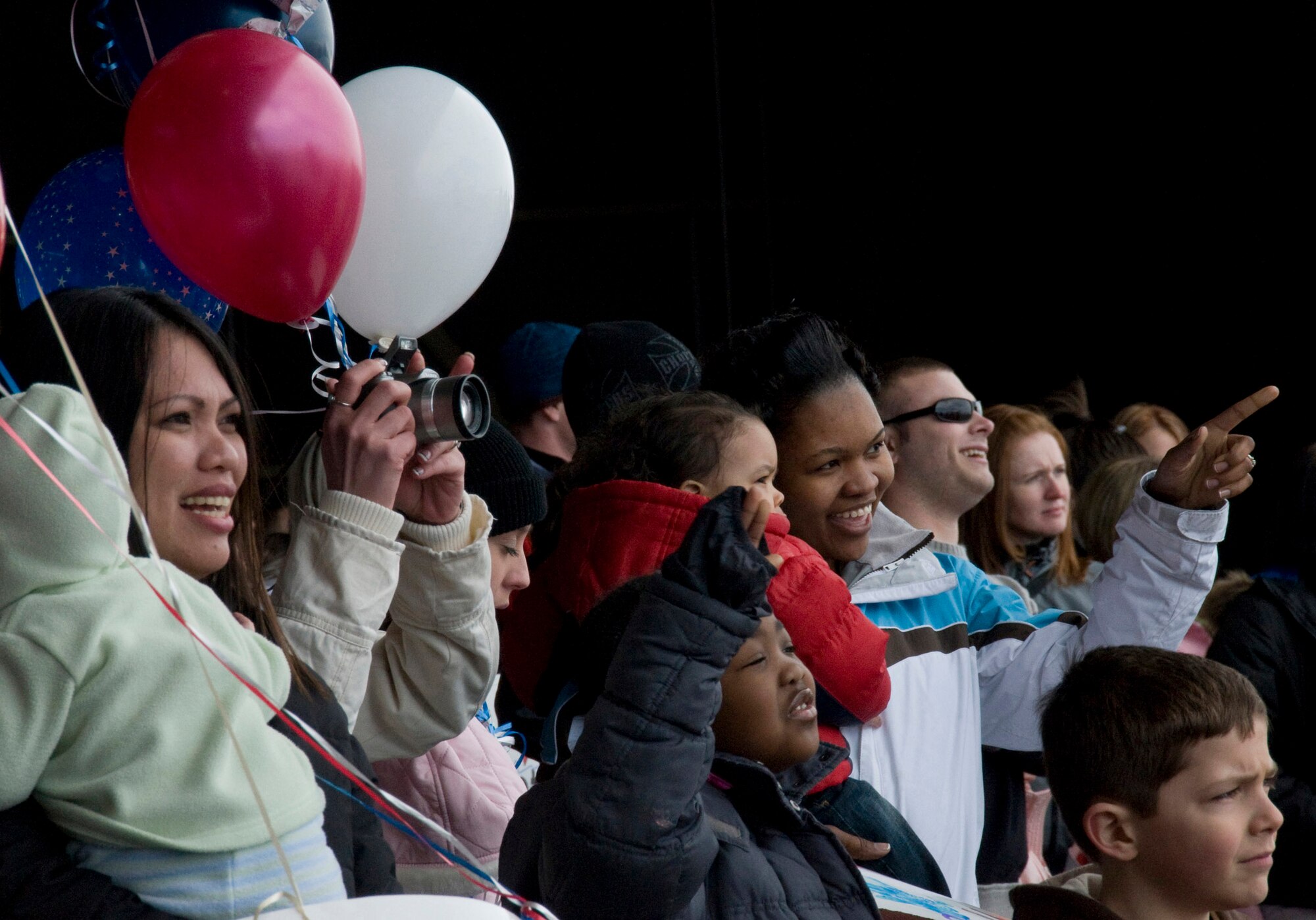 Family members cheer the arrival of members of the 14th Fighter Squadron and 35th Maintenance Squadron March 1 at Misawa Air Base, Japan. Families gathered for their loved ones to return from a deployment to Joint Base Balad, Iraq. (U.S. Air Force photo/Staff Sgt. Araceli Alarcon) 
