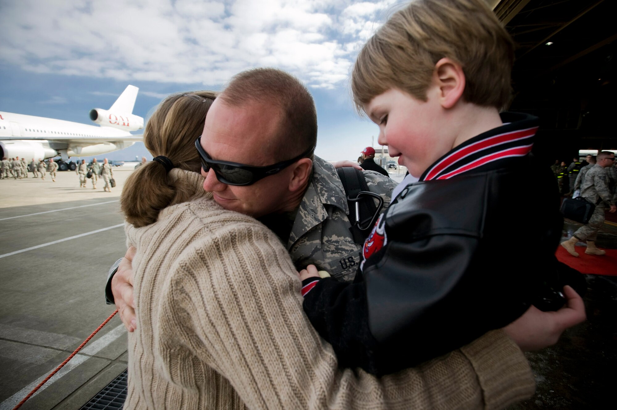 Staff Sgt. Adam Yeo hugs his family March 1 at Misawa Air Base, Japan. Sergeant Yeo, a 35th Maintenance Squadron phase crew chief, returned from a deployment to Joint Base Balad, Iraq, in support of the 14th Fighter Squadron. He and his family hail from Florida. (U.S. Air Force photo/Staff Sgt. Samuel Morse) 
