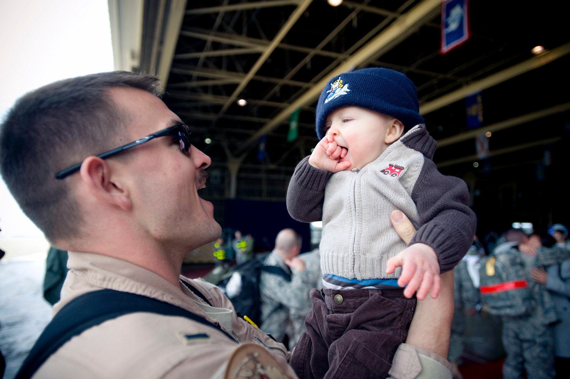 1st Lt. Ryan Cross holds his son March 1 at Misawa Air Base, Japan. Lieutenant Cross, a 14th Fighter Squadron pilot, returned from a deployment to Joint Base Balad, Iraq. He and his family hail from Niceville, Fla. (U.S. Air Force photo/Staff Sgt. Samuel Morse) 

