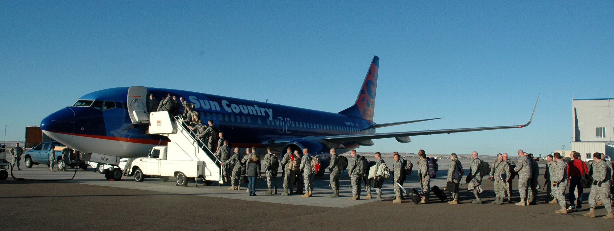 More than 230 Airmen from the 819th RED HORSE Squadron, 341st Missile Wing and 219th RHS board a commercial aircraft heading to Fort McCoy, Wis., for combat skills training prior to a  a six-month deployment to southwest Asia in support of the Global War on Terrorism. (U.S. Air Force photo/Senior Airman Dillon White)