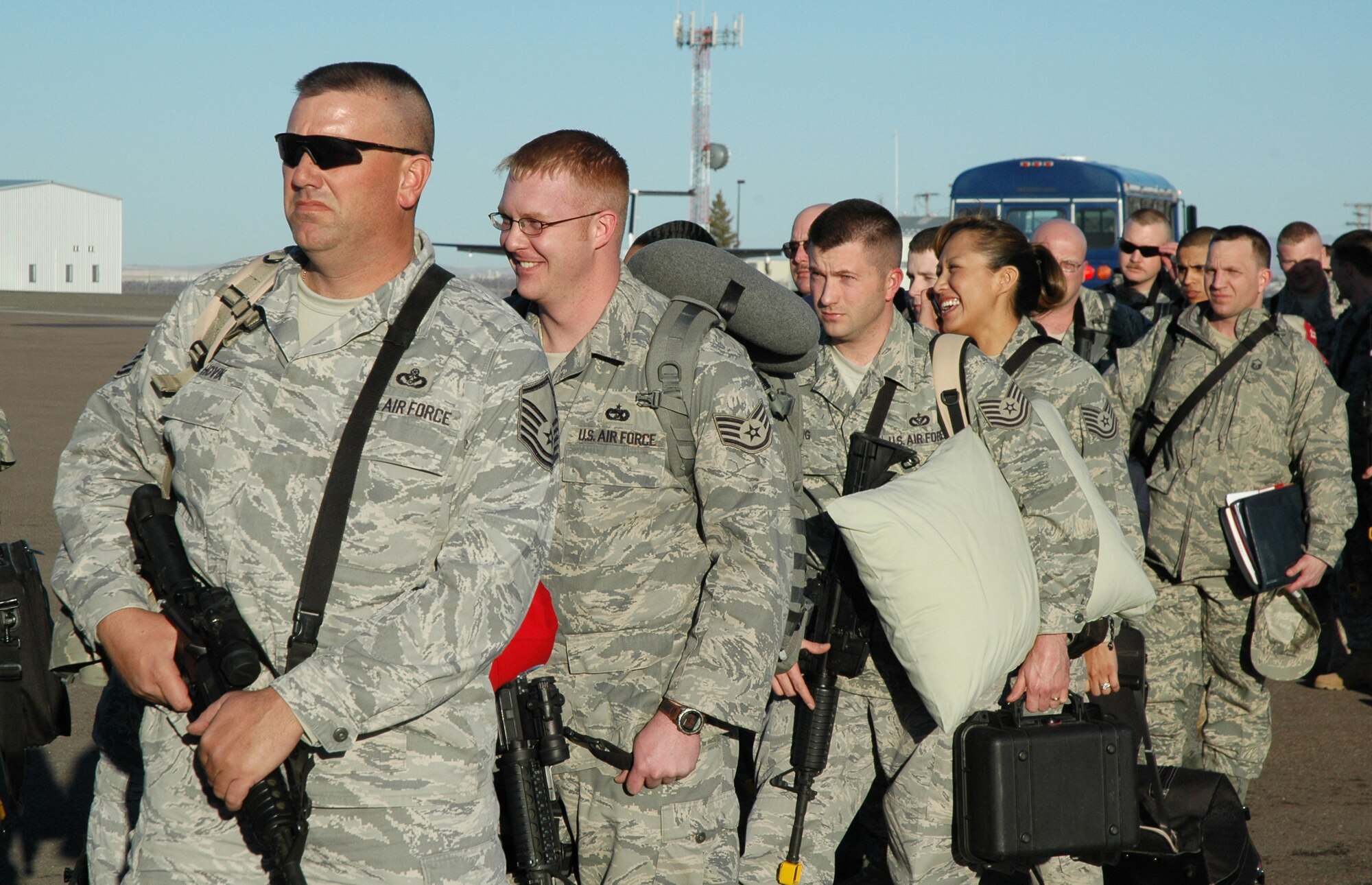 More than 230 Airmen from the 819th RED HORSE Squadron, 341st Missile Wing and 219th RHS board a commercial aircraft heading to Fort McCoy, Wis., for combat skills training prior to a  a six-month deployment to southwest Asia in support of the Global War on Terrorism. (U.S. Air Force photo/Senior Airman Dillon White)