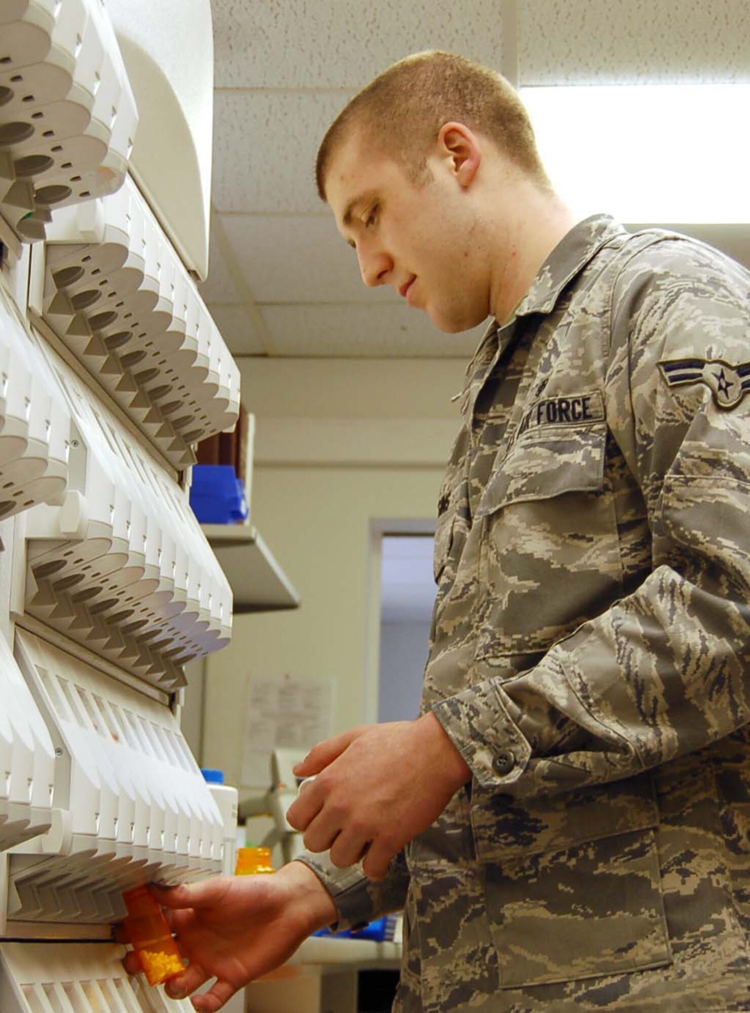 SPANGDAHLEM AIR BASE, Germany – Airman 1st Class Jared Higgins, 52nd Medical Support Squadron pharmacy technician, dispenses pills into a bottle at the Spangdahlem Medical Clinic March 4, 2009. The 52nd Medical Group is celebrating Patient Safety Week March 8 to 14, 2009. During the week base medical professionals will focus on educating patients on the safe use of medications. (U.S. Air Force photo by Staff Sgt. Tammie Moore)