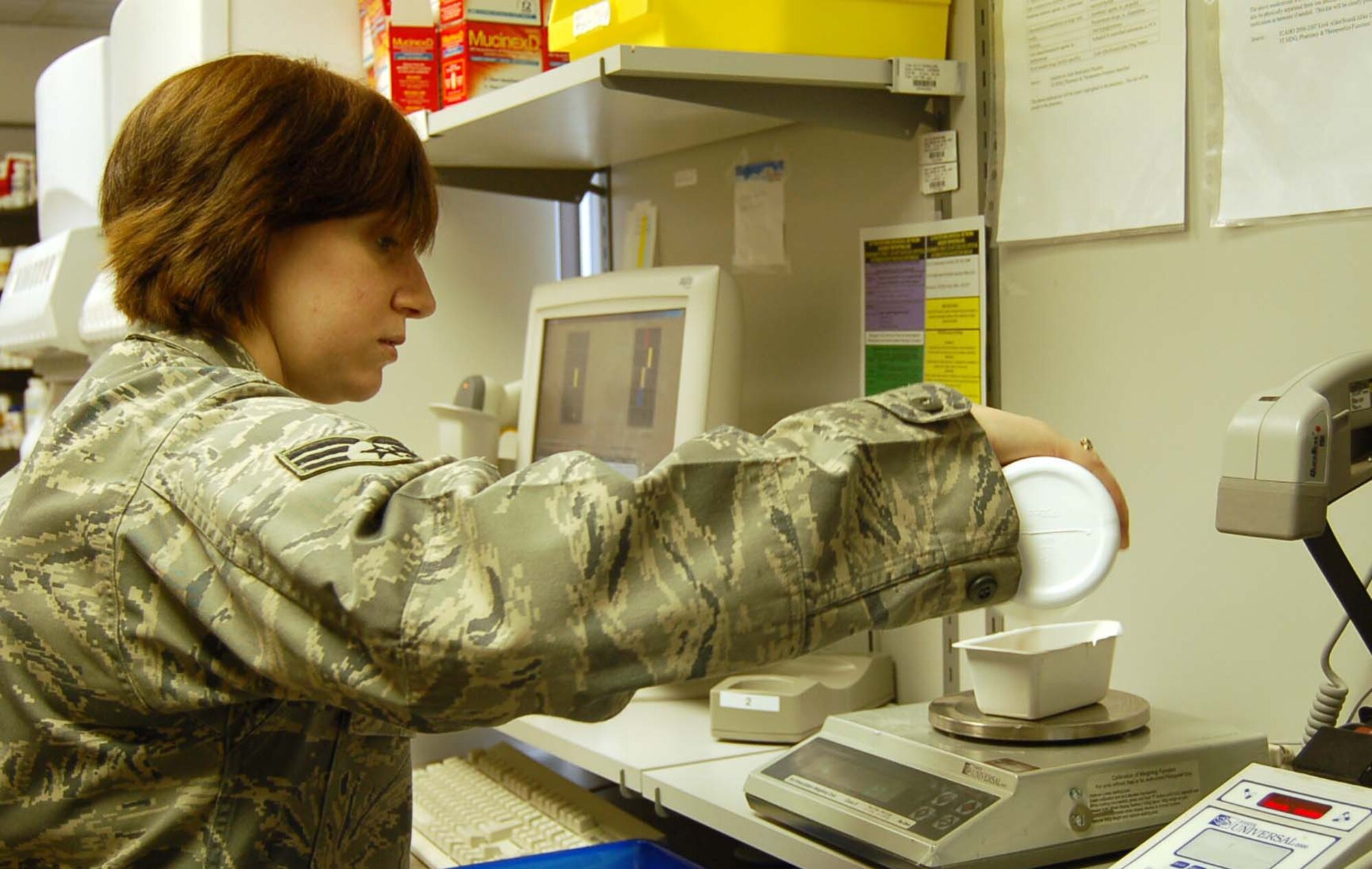 SPANGDAHLEM AIR BASE, Germany – Senior Airman Michelle Moffett, 52nd Medical Support Squadron pharmacy technician, pours pills into a bowl on a specialized scale at the Spangdahlem Medical Clinic March 4, 2009. The scale calculates the number of pills in the bowl based on weight. The 52nd Medical Group is celebrating Patient Safety Week March 8 to 14, 2009. Patients visiting a primary care manager should receive a print out of the drugs they are currently prescribed. If one is not given ask for it. (U.S. Air Force photo by Staff Sgt. Tammie Moore)