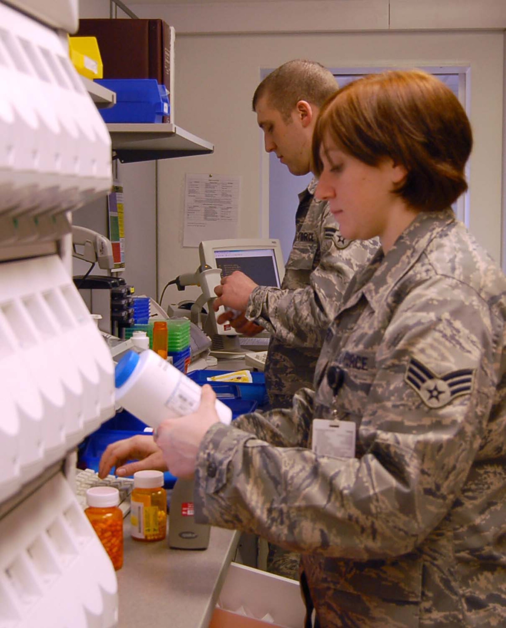 SPANGDAHLEM AIR BASE, Germany – Senior Airman Michelle Moffett and Airman 1st Class Jared Higgins prepare customer prescriptions at the Spangdahlem Medical Clinic March 4, 2009. The 52nd Medical Group is celebrating Patient Safety Week March 8 to 14, 2009. During the week, base medical professionals will focus on educating patients on the safe use of medications.  Both Airmen are pharmacy technicians assigned to the 52nd Medical Support Squadron. (U.S. Air Force photo by Staff Sgt. Tammie Moore)