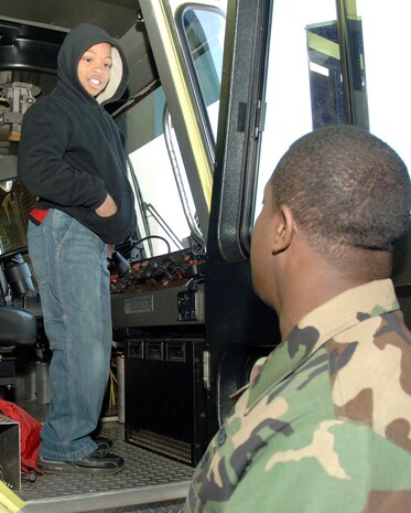 Staff Sgt. Joseph Tobler explains to Jordan Johnson the inside of a fire truck during a tour of the 437th Civil Engineer Squadron Fire and Emergency Services Flight here March 3. Students from Devon Forest Elementary school in Goose Creek, S.C. were given the opportunity to take part in this field trip to inspire them to succeed and realize that they can achieve personal goals if they work hard towards accomplishing them.  Sergeant Tobler is a firefighter with the 437 CES. (U.S. Air Force photo/Staff Sgt. Marie Cassetty)