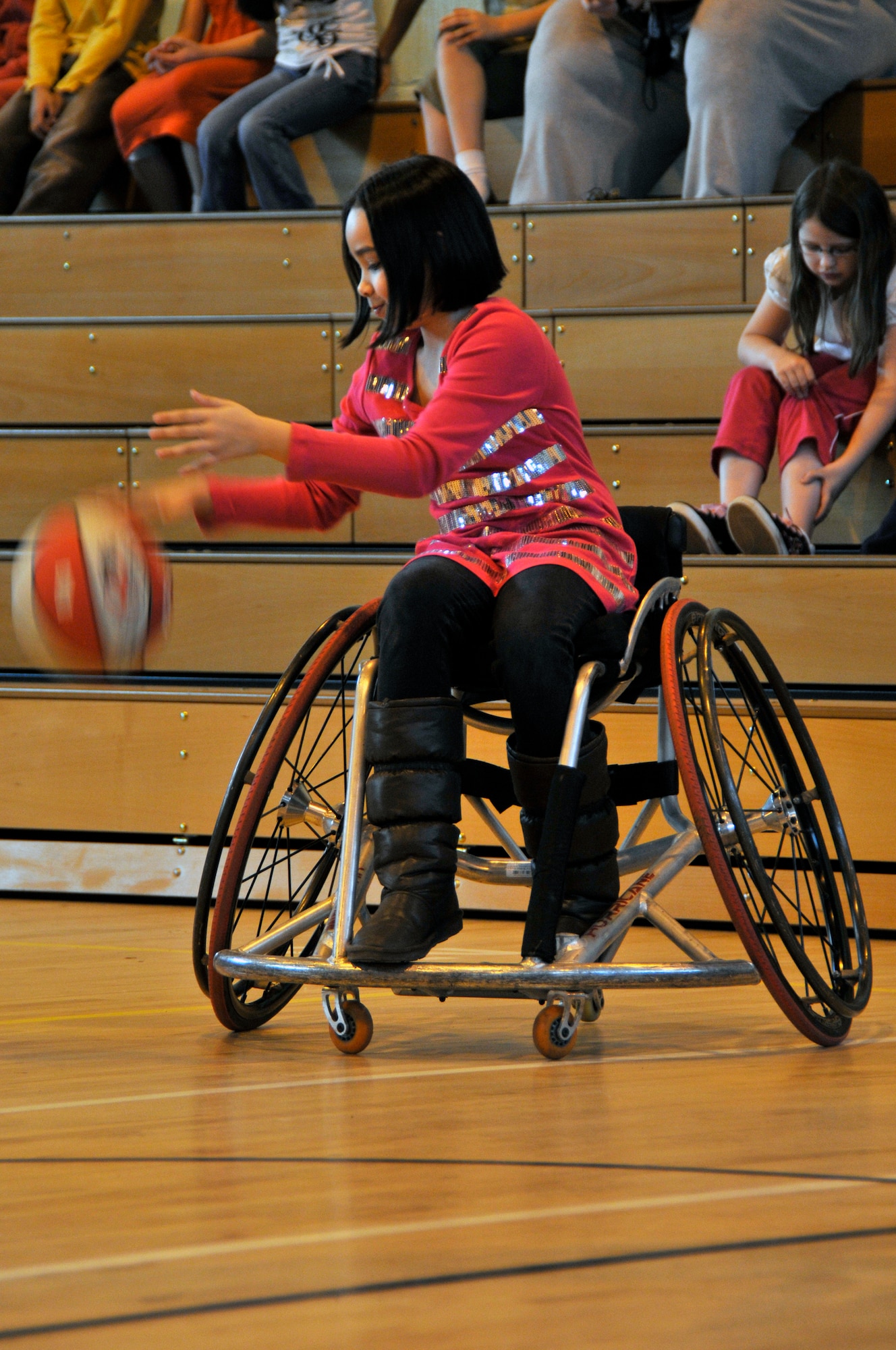 Donita Lambie, daughter of Tech Sgt. Gregory Lambie, 48 Aircraft Maintenance Squadron, practices her dribbling skills Feb.19 at RAF Lakenheath, England. The Bury Bombers are a Wheelchair basket ball team based in Bury St. Edmunds (U.S. Air Force photo by Airman 1st Class Perry Aston) 