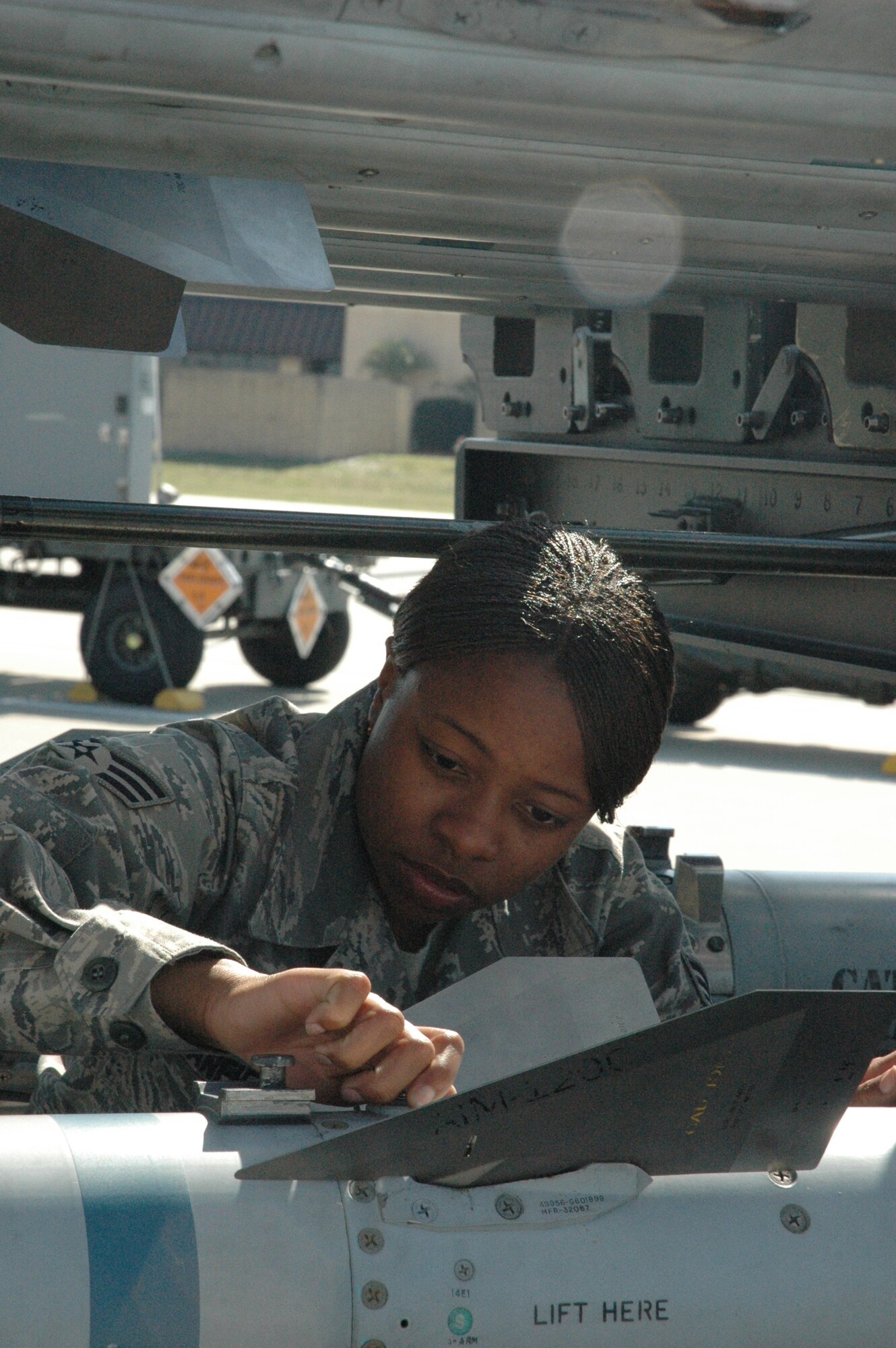 TYNDALL AIR FORCE BASE, Fla. -- Senior Airman Candace Stanfield, 58th Aircraft Maintenance Squadron armament specialist, replaces a missile on an F-15 missile trailer during a Weapons Systems Evaluation Program at Tyndall AFB, Fla.  On Feb. 16 more than 100 maintainers temporarily left the 33rd Fighter Wing at Eglin AFB, Fla., to support the two-week evaluation. (U.S. Air Force photo/Airman First Class Veronica McMahon)