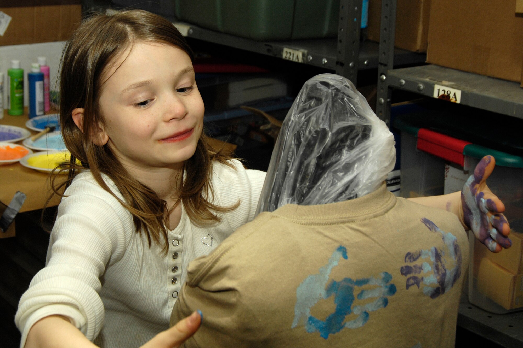 HANSCOM AIR FORCE BASE, Mass. – Abigail Belko wraps a hug around a t-shirt to send to her deployed parent during the Airman and Family Readiness Center’s Hearts Apart program on Feb. 26. Families that have loved ones deployed are welcome to participate in the Hearts Apart program. (U.S. Air Force photo by Linda LaBonte Britt)