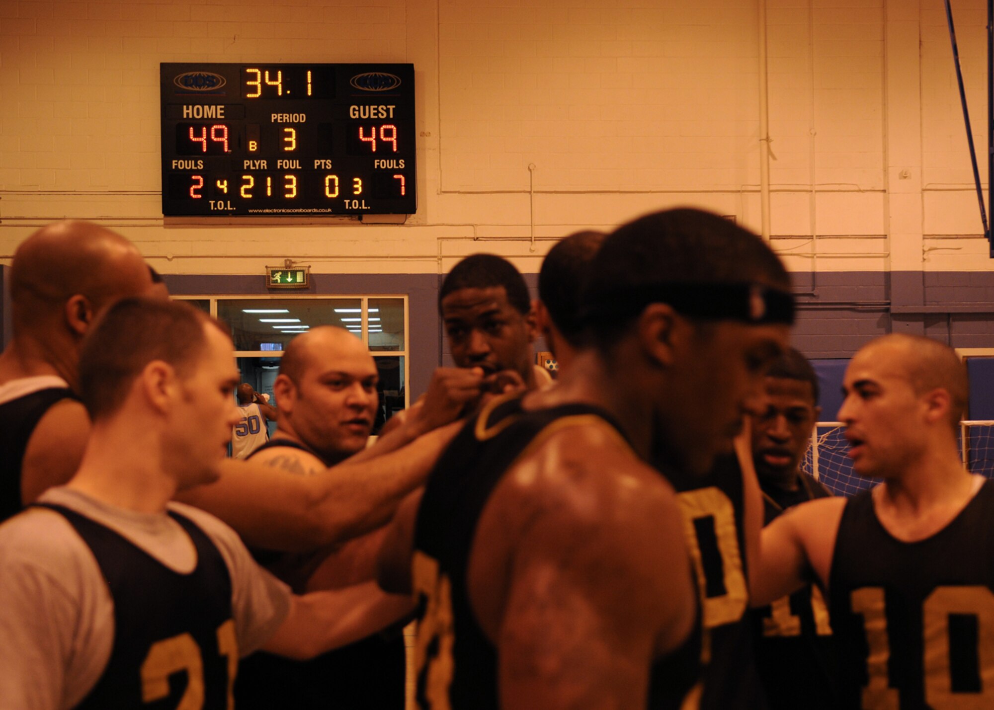 With the score tied at 49, the 100th Maintenance Group huddles together during a timeout for a plan at the final shot in regulation during the Intramural Basketball Championship game at the Main Fitness Center Feb. 25, 2009, at RAF Mildenhall, England. With the missed final attempt, the game went into a five-minute overtime period where the 100th Maintenance Group pulled off a victory against the 100th Logistics Readiness Squadron with 55-51 point win, making the 100th MXG RAF Mildenhall’s 2009 Intramural Basketball Champions. (U.S. Air Force photo by Staff Sgt. Jerry Fleshman)