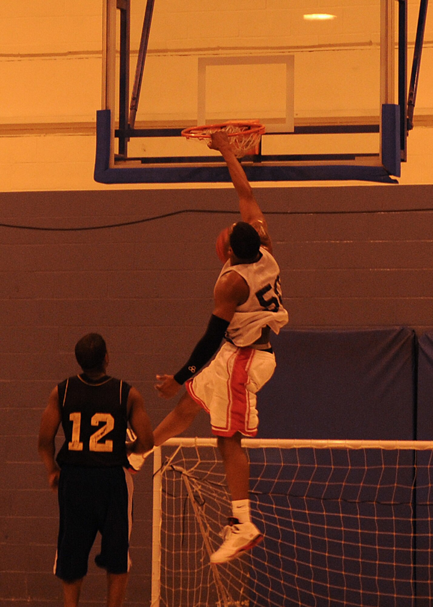 Christopher Williams from the 100th Logistics Readiness Squadron dunks the basketball after a fast break during the Intramural Basketball Championship game at the Main Fitness Center Feb. 25, 2009, at RAF Mildenhall, England. After two exciting periods of back and forth action the score was 49-49 at the end of regulation play. After a five-minute overtime period the 100th Maintenance Group pulled out a 55-51 point victory over LRS making them RAF Mildenhall’s 2009 Intramural Basketball Champions. (U.S. Air Force photo by Staff Sgt. Jerry Fleshman)