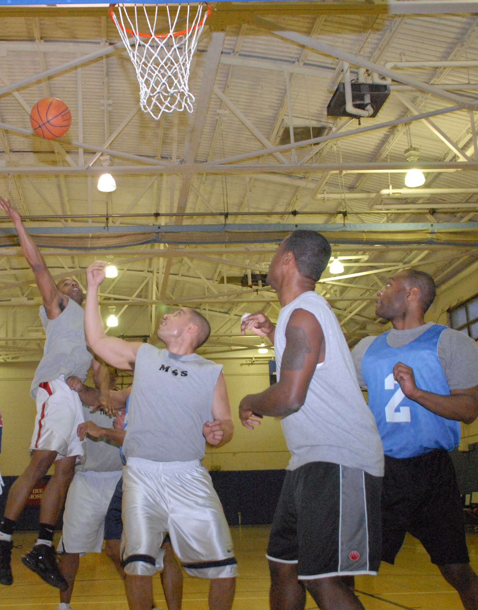 Rhonnell Singleton, 436th Force Support Squadron, reaches for a rebound during a basketball game Feb. 24 at the Fitness Center.  (U.S. Air Force photo/ Airman 1st Class Shen-Chia Chu)