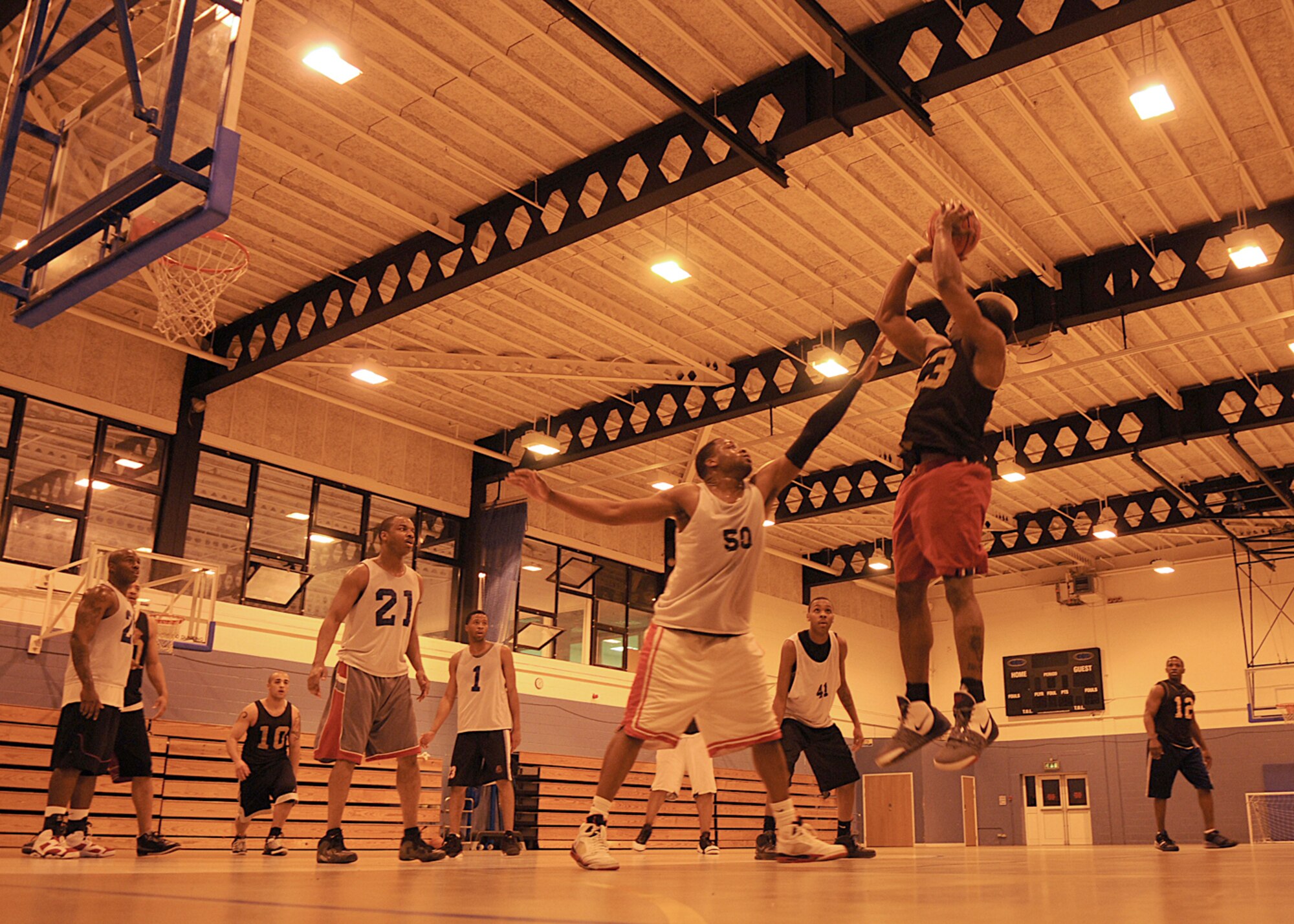 Jonnie Story from the 100th Maintenance Group, pulls up for a jump shot over Christopher Williams from the 100th Logistics Readiness Squadron, during the Intramural Basketball Championship game at the Main Fitness Center Feb. 25, 2009, at RAF Mildenhall, England. Both teams battled for two 20-minute periods with the score of 49-49 at the end of regulation play. A five-minute overtime period took place where MXG edged out LRS in a 55-51 point victory to become RAF Mildenhall’s 2009’s Intramural Basketball Champions. (U.S. Air Force photo by Staff Sgt. Jerry Fleshman)