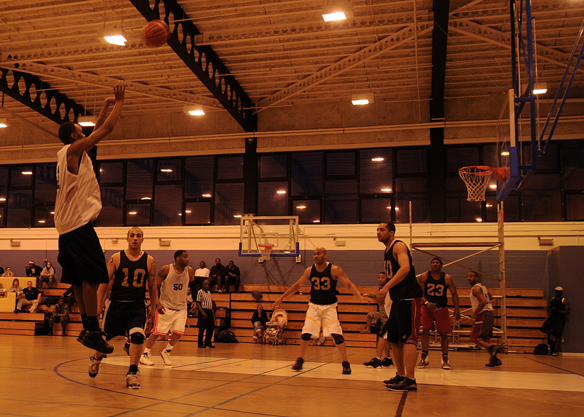 Brian Roy from the 100th Logistics Readiness Squadron, spots up a 3 point attempt during the Intramural Basketball Championship game at the Northside Fitness Center Feb. 25, 2009, at RAF Mildenhall, England. The championship game between the 100th Logistics Readiness Squadron and the 100th Maintenance Group, ended with a final score of 55-51 in an overtime victory making the 100th MXG, RAF Mildenhall’s 2009 Intramural Basketball Champions. (U.S. Air Force photo by Staff Sgt. Jerry Fleshman)