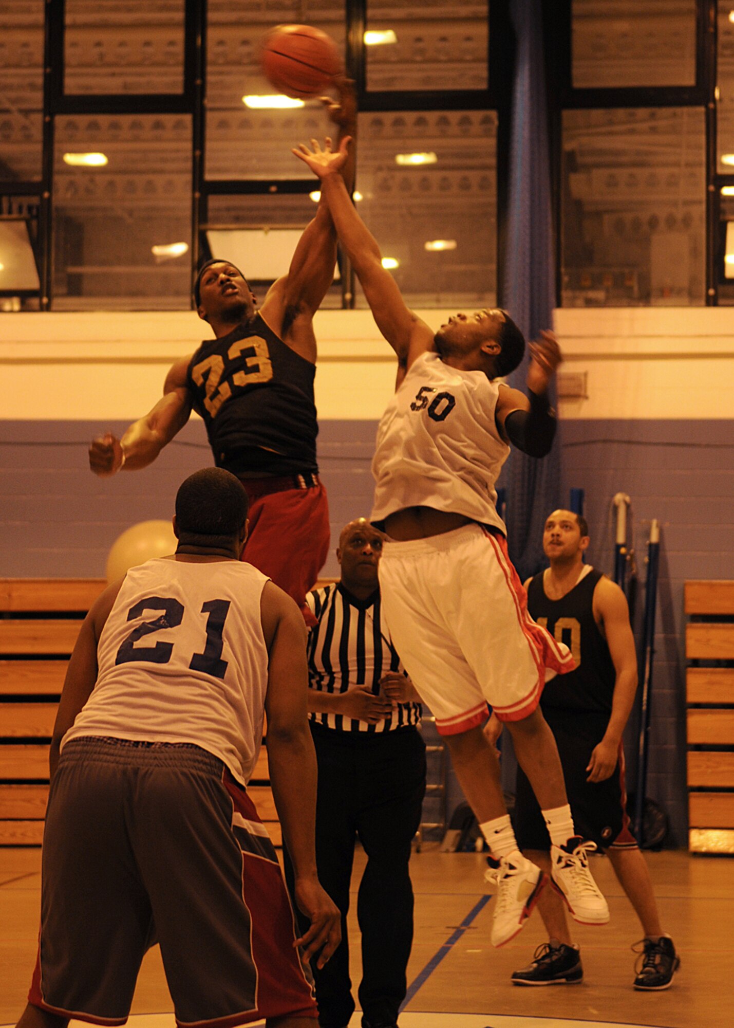 Jonnie Story from the 100th Maintenance Group, wins the tip off against Christopher Williams from the 100th Logistics Readiness Squadron, at the start of the Intramural Basketball Championship game at the Northside Fitness Center Feb. 25, 2009, at RAF Mildenhall, England. Both teams battled hard for two 20-minute periods with the score of 49-49 at the end of regulation play. A five-minute overtime period took place where MXG edged out LRS in a 55-51 victory to become RAF Mildenhall’s 2009’s Intramural Basketball Champions. (U.S. Air Force photo by Staff Sgt. Jerry Fleshman)