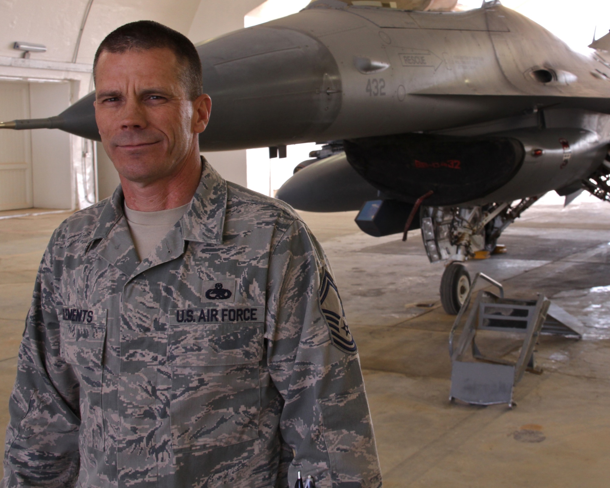 JOINT BASE BALAD, Iraq -- Senior Master Sgt. Scott Clements, 4th Aircraft Maintenance Unit productions supervisor deployed from Hill Air Force Base, Utah, stands in front of an F-16 Fighting Falcon here March 2. Clements, who uses a prosthetic leg, was involved in an accident a few years ago requiring a below-the-knee amputation on his left leg; however that doesn't stop him from being in the fight. Clements is from Riverdale, Utah. (U.S. Air Force photo/Tech. Sgt. Lionel Castellano)