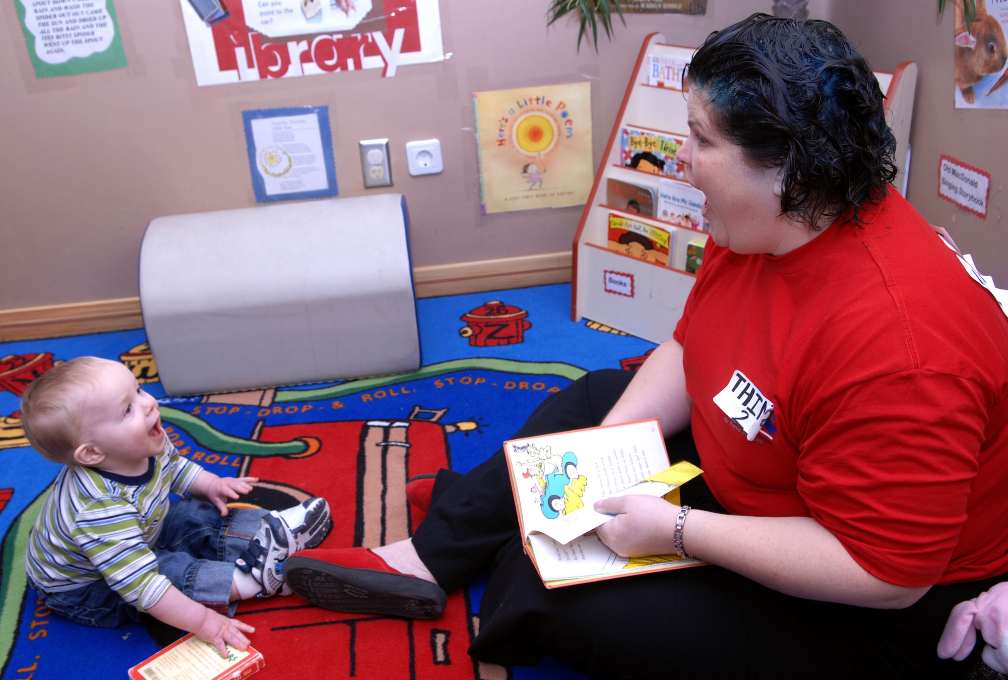 Jeannie Gooch, Incirlik Child Development Center director dressed as “Thing 2,” reads “Green Eggs and Ham” by Dr. Seuss as Reese Nichols actively listens during the Child Development Center’s “Seussentenial." The “Seussentenial” is a celebration of author Dr. Seuss’ 100th birthday, if he were alive today, by feeding the children green eggs and ham for breakfast as well as reading them a few of Dr. Seuss’ books. (U.S. Air Force photo/Senior Airman Erica Stewart)