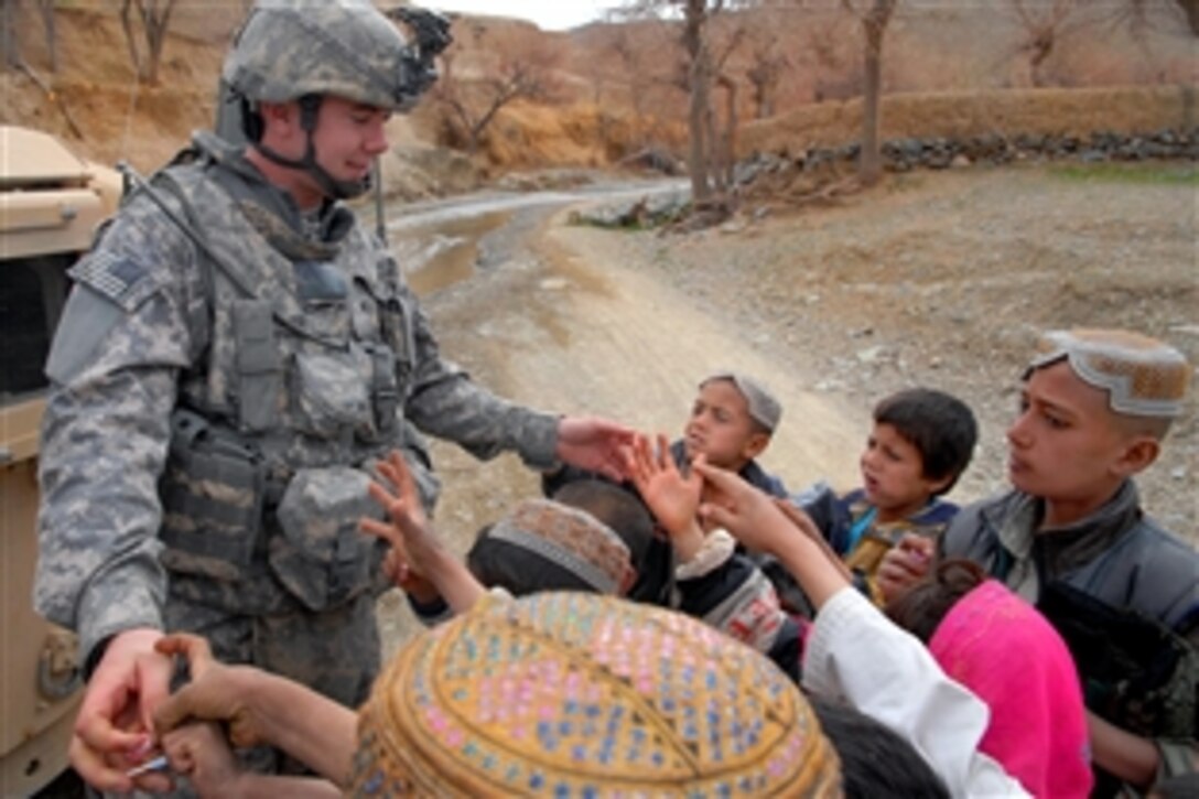 U.S. Army Pvt. Charles Joiner hands out candy to village children during a supply distribution near Forward Operation Base Lane, Zabul province, Afghanistan, Feb. 28, 2009. 
Joiner is assigned to Company B, 1st Battalion, 4th Infantry Regiment.