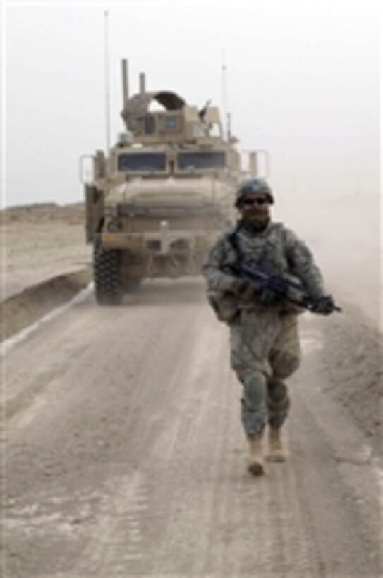 U.S. Army Spc. Lonnie Kirk from 1st Battalion, 2nd Infantry Regiment, attached to 1st Stryker Brigade Combat Team, 25th Infantry Division patrols between Iraqi army checkpoints in the village of Tawilla in the Diyala province of Iraq on Feb. 27, 2009.  