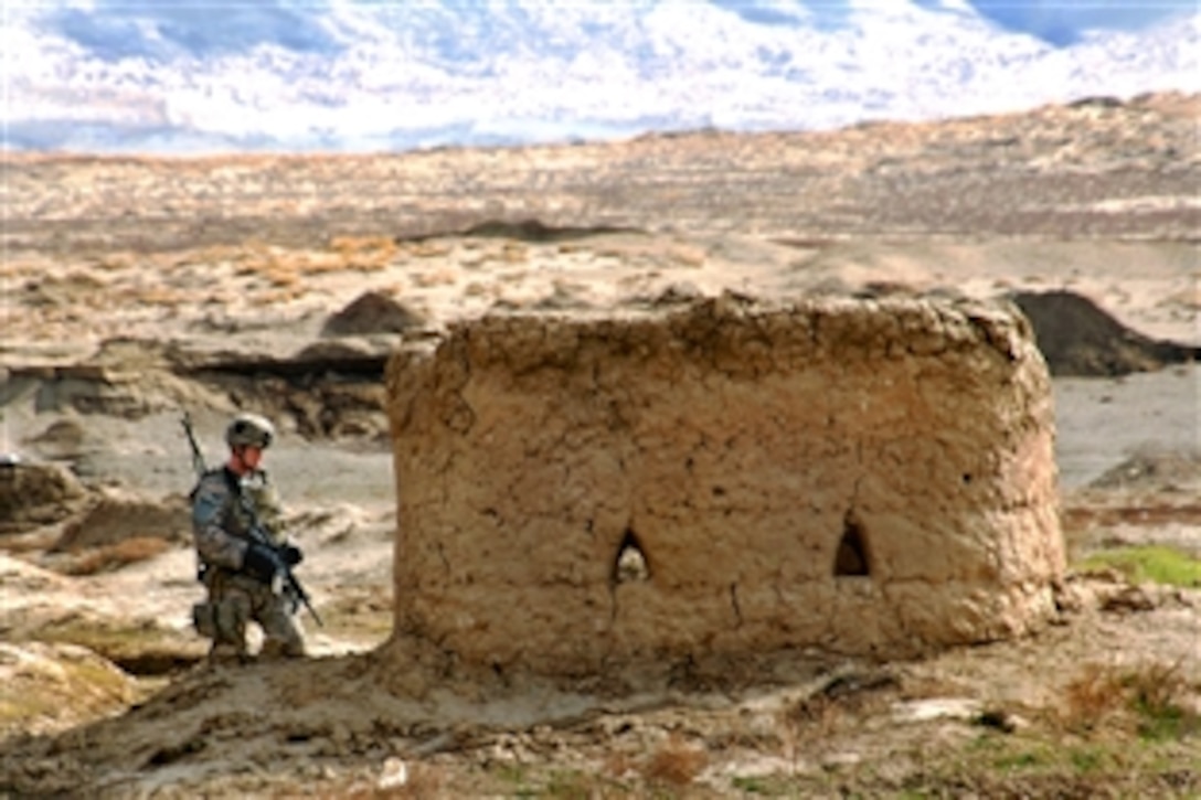 A U.S. Army soldier searches a mud hut during a weapons cache patrol in Bagram, Afghanistan, March 2, 2009. The soldier is assigned to the 101st Airborne Division's Company A, 1st Platoon Personnel Security Detail.