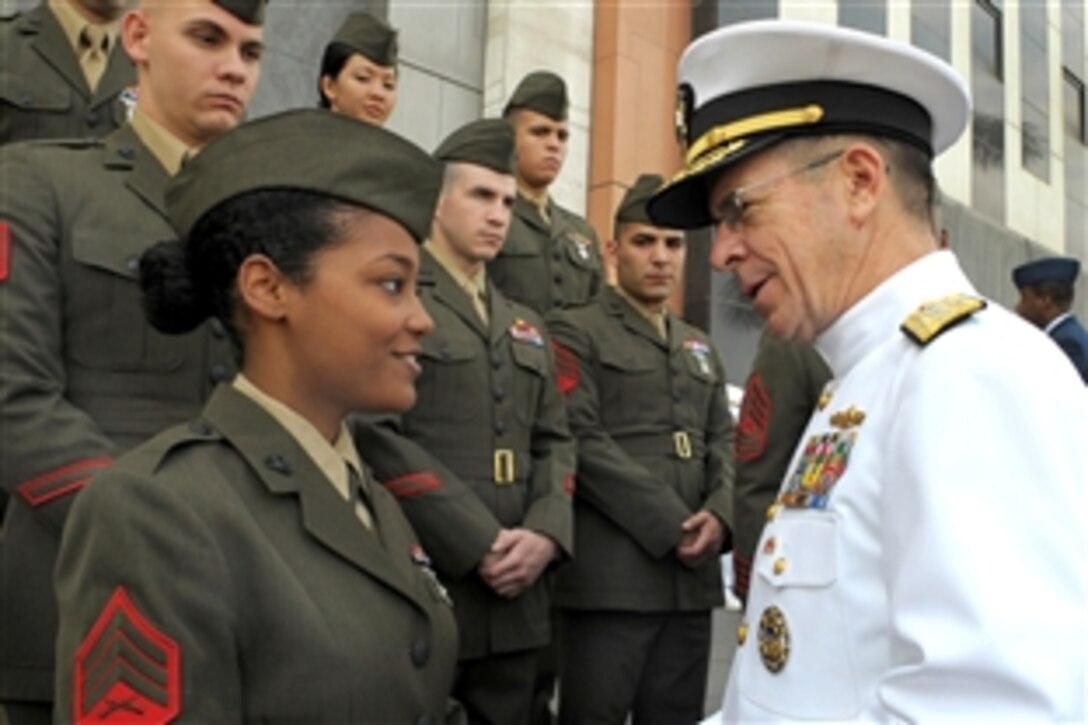 U.S. Navy Adm. Mike Mullen, chairman of the Joint Chiefs of Staff, speaks with U.S. Marine Corps Sgt. Heather Thornton outside the U.S. embassy in Lima, Peru, March 4, 2009. The chairman visited the country to meet with senior Peruvian officials and toured the Naval Medical Research Center Detachment Peru. 