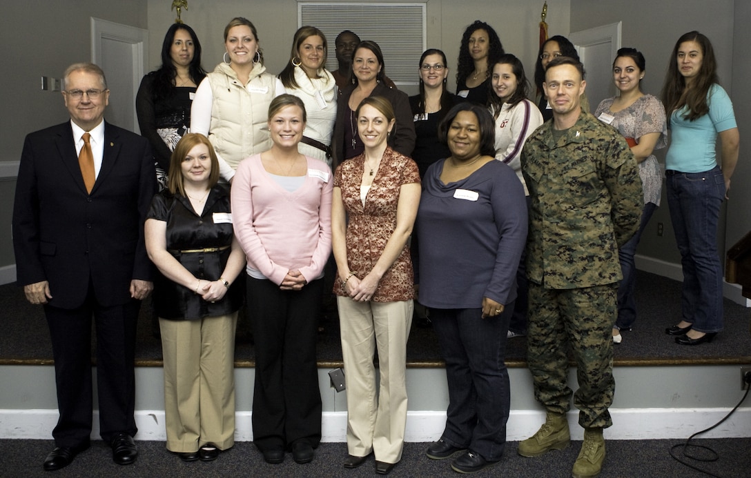 Col. Richard P. Flatau Jr., the commanding officer of Marine Corps Base Camp Lejeune, stands with the selected military spouses who recieved scholarships from Campbell University March 6