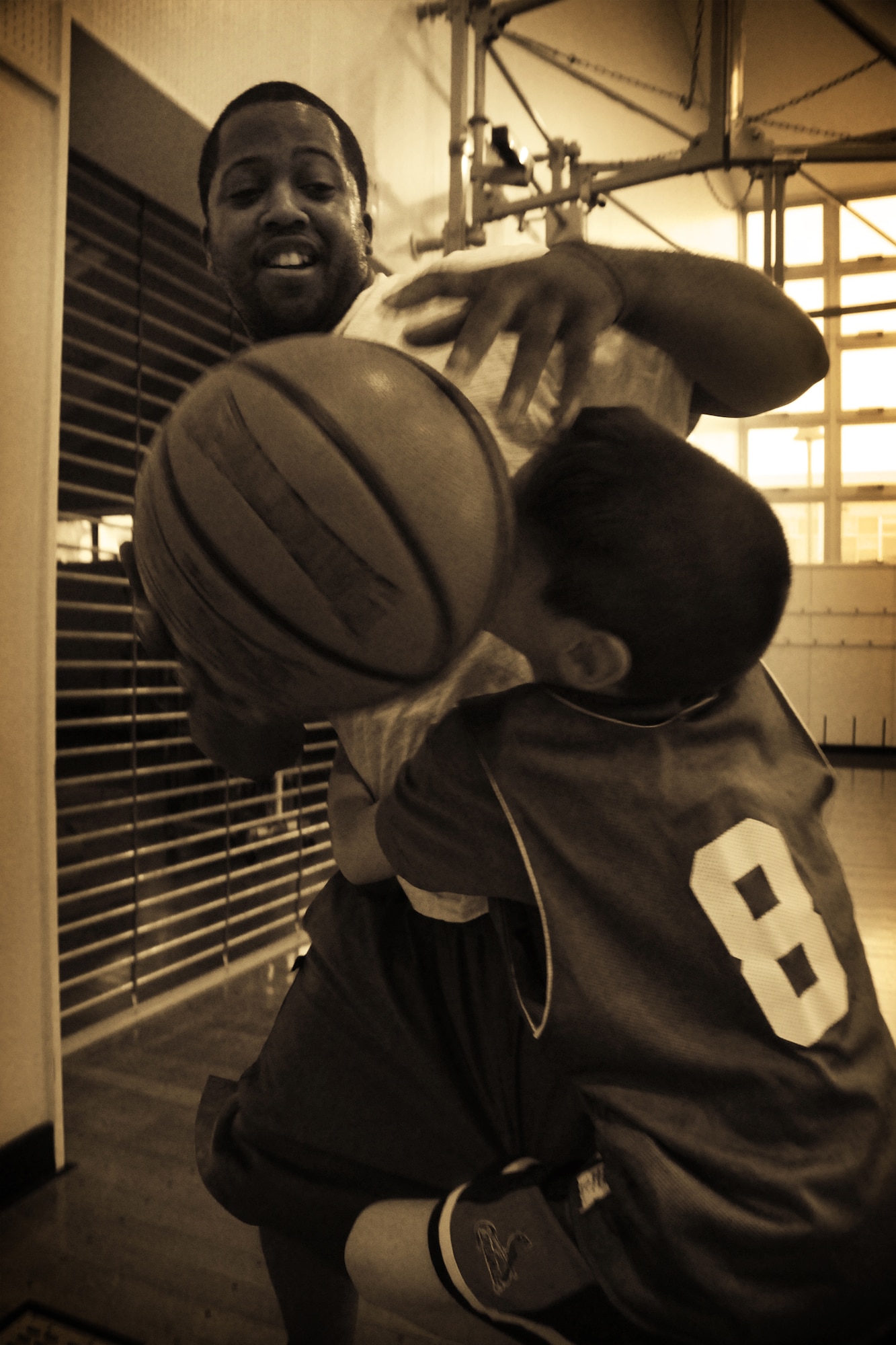 MISAWA AIR BASE, Japan -- Tyler Beverly playfully guards Airman 1st Class Jamel Slater, volunteer coach and 610th Air Control Flight weapons-director technician, during practice Feb. 27, 2009. One goal for the coaches was to make practice as enjoyably as possible for the children. (U.S. Air Force photo by Senior Airman Jamal D. Sutter)