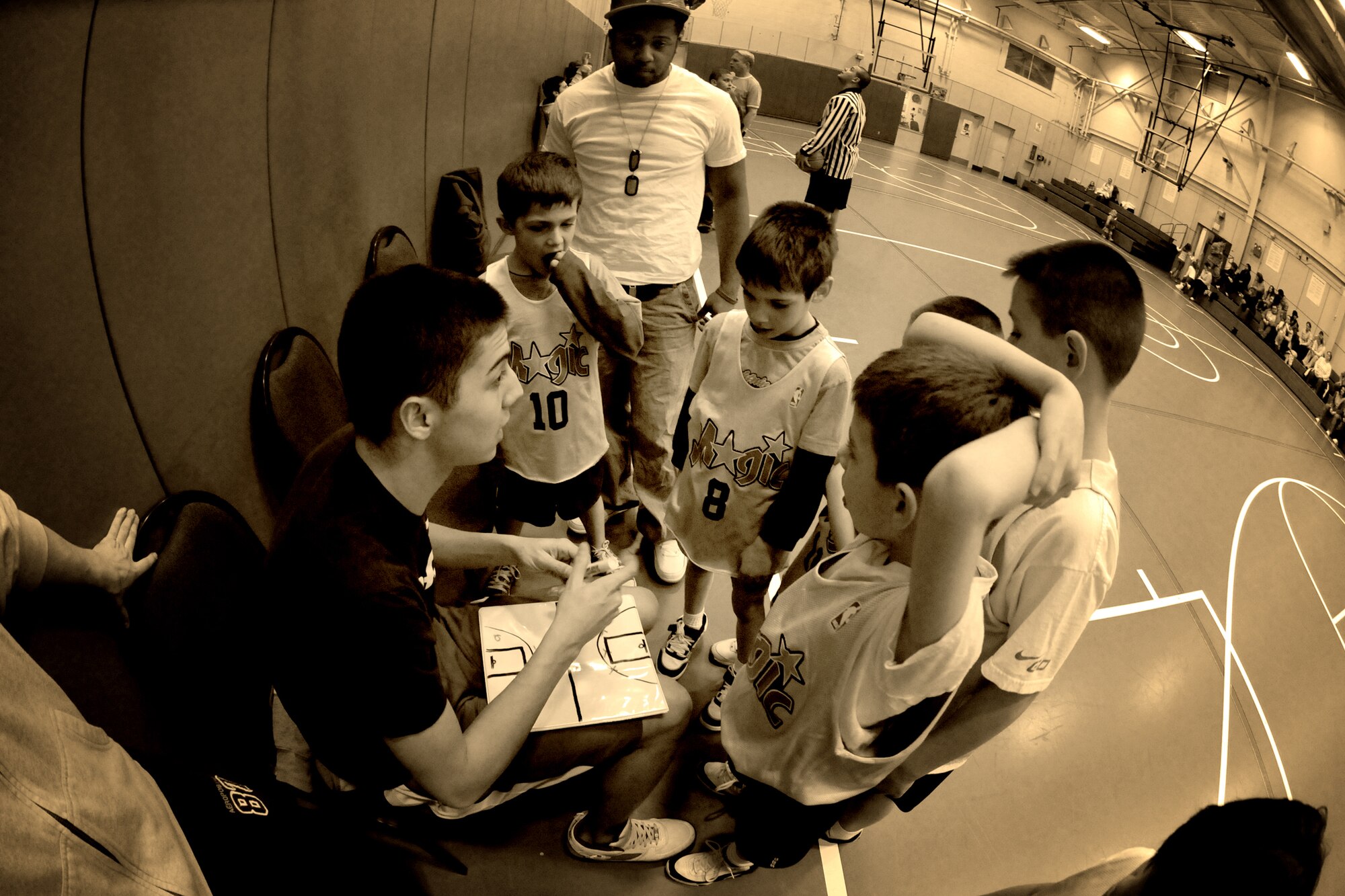 MISAWA AIR BASE, Japan -- Airman 1st Class Troy Teal, volunteer coach and 610th Air Control Flight weapons-director technician, advises the team during a basketball game Feb. 3, 2009. The game was played at the Lunney Youth Center. (U.S. Air Force photo by Senior Airman Jamal D. Sutter)