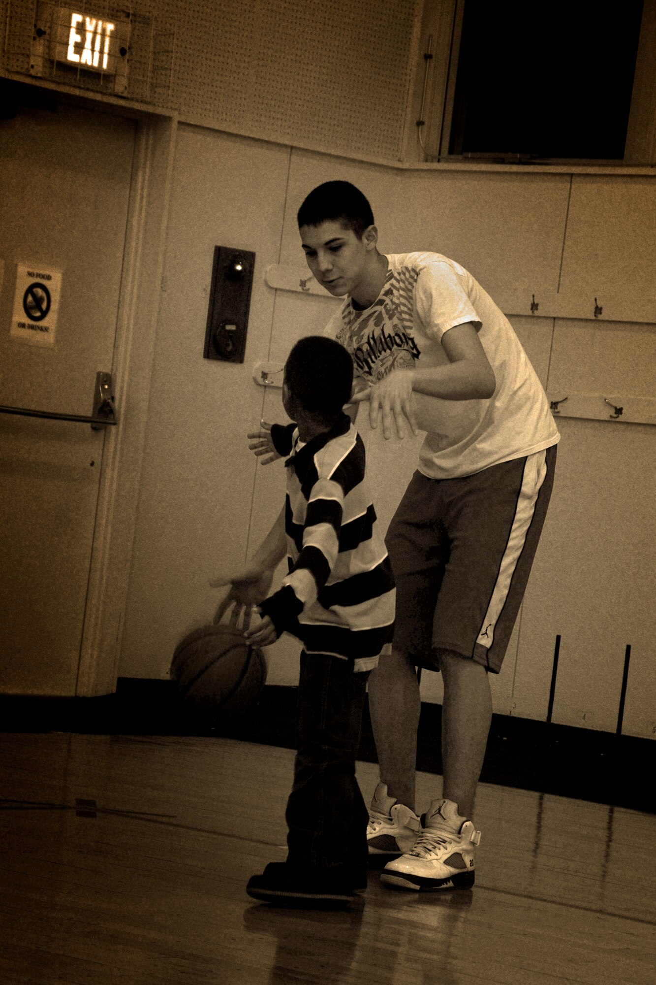 MISAWA AIR BASE, Japan -- Airman 1st Class Troy Teal, volunteer coach and 610th Air Control Flight weapons-director technician, gives player, Nathaniel Mickles, dribbling tips Jan. 30, 2009. Nathaniel is the son of Staff Sgt. Trisha Mickles, 35th Medical Operation Squadron. (U.S. Air Force photo by Senior Airman Jamal D. Sutter)