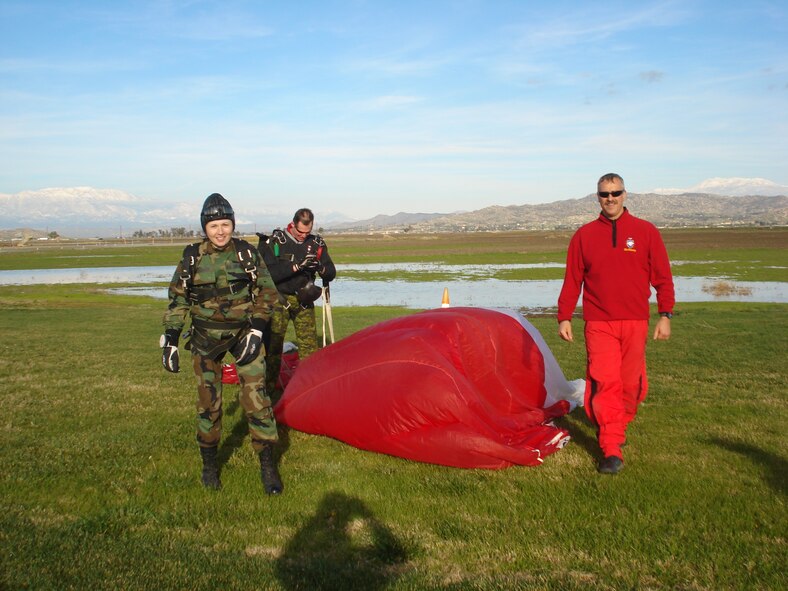 While training for their upcoming demonstration season, the Canadian SkyHawks gave two 452 AMW Public Affairs employees tandem jumps during their practice sessions. Staff Sgt. Megan Crusher, left, 452 AMW public affairs, walks away from a successful landing. (U.S. Air Force photo by Valerie Palacios) 