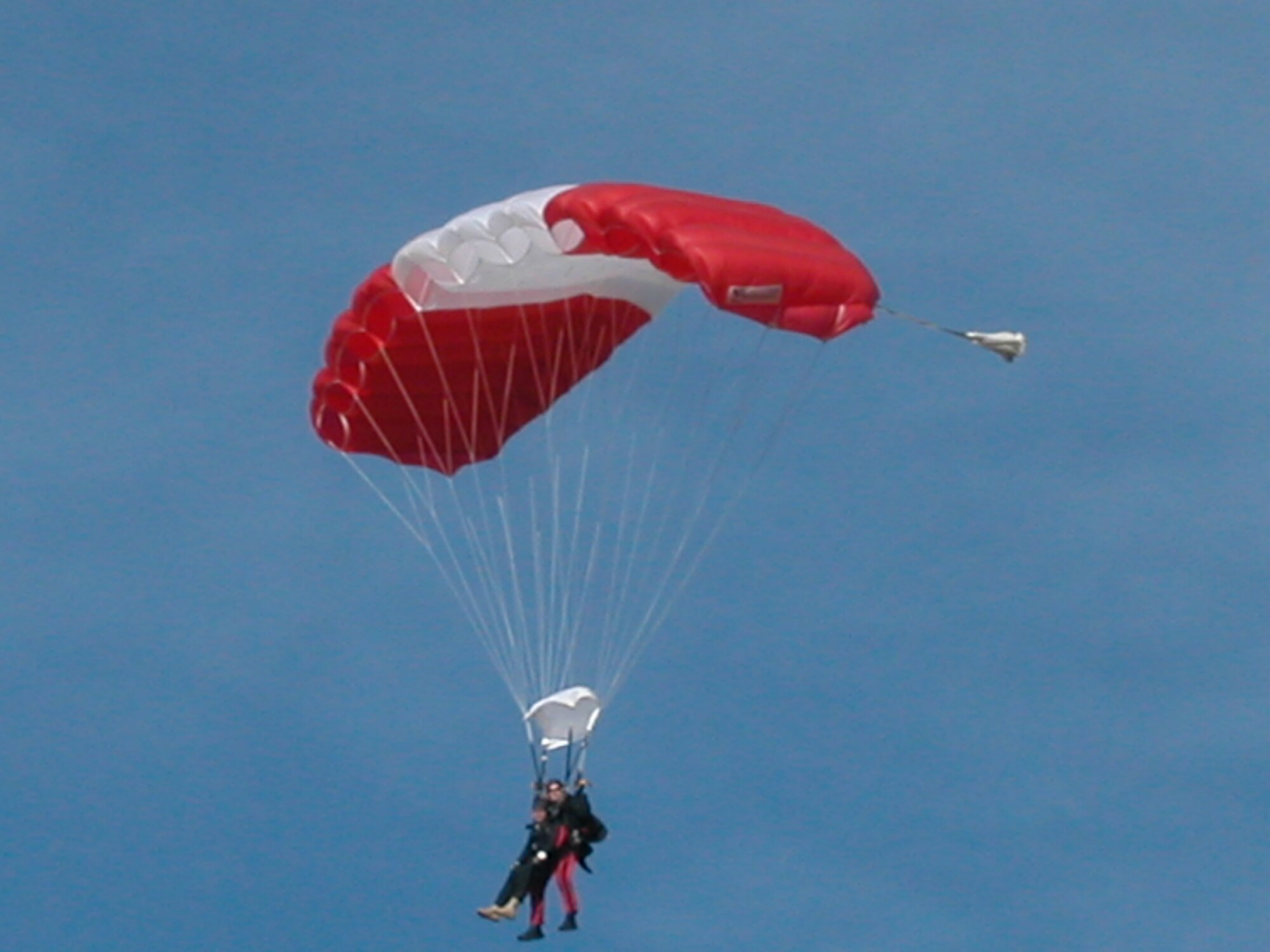 While training for their upcoming demonstration season, the Canadian SkyHawks gave two 452 AMW Public Affairs employees tandem jumps during their practice sessions. Ms. Valerie Palacios, community relations expert, and Corporal
Sebastien Pinard, parachute rigger for Canadian SkyHawks parachuting team, float back to solid ground after their jump. (U.S. Air Force photo by Staff Sgt Megan Crusher)