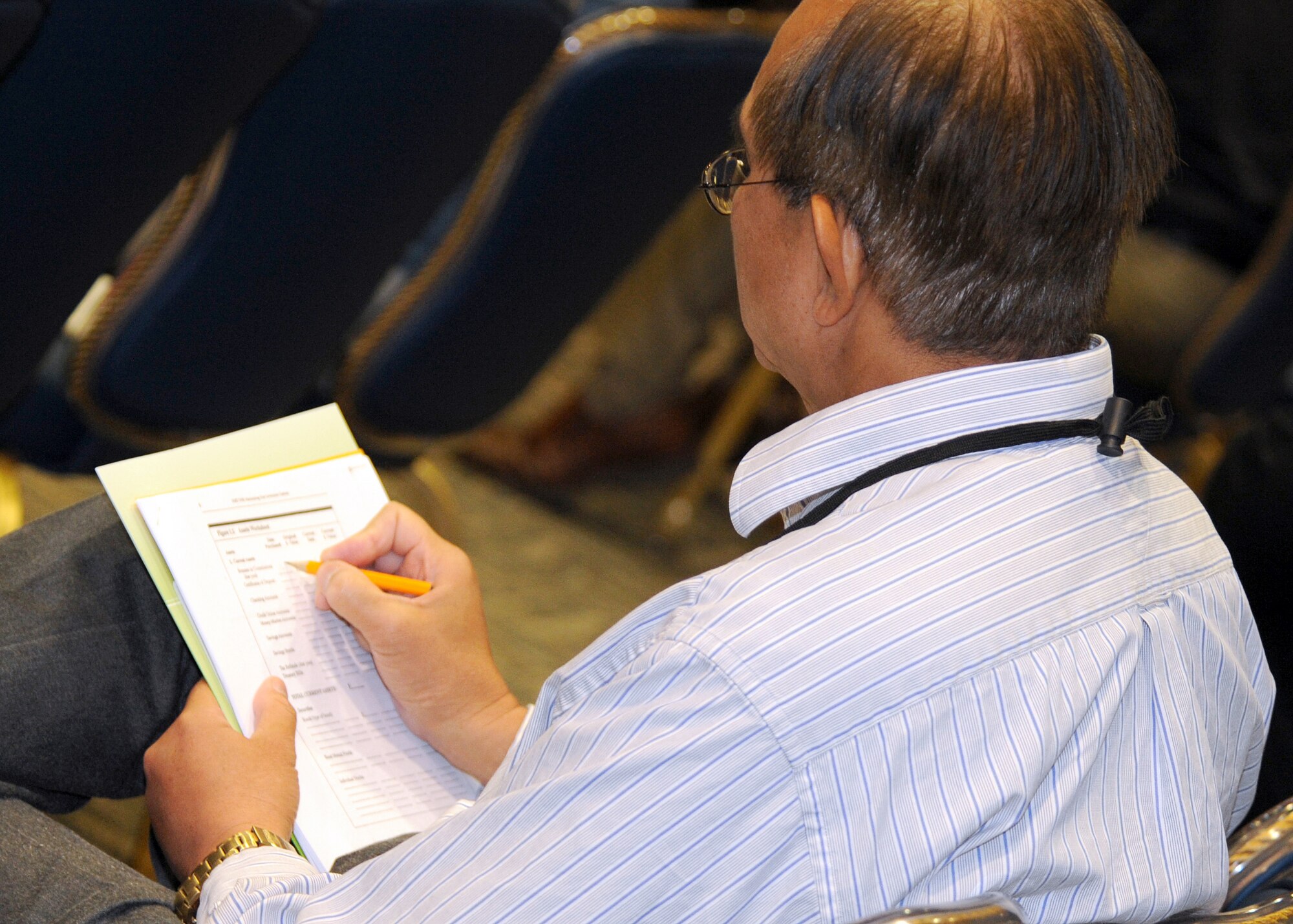 An audience member writes his financial plan as Jordan Goodman talks about ways to be savvy in today's economy, Feb. 26.  Mr. Goodman was one of the keynote speakers and financial experts at the Los Angeles AFB Financial Roadshow held at the Gordon Conference Center. (Photo by Atiba S. Copeland)