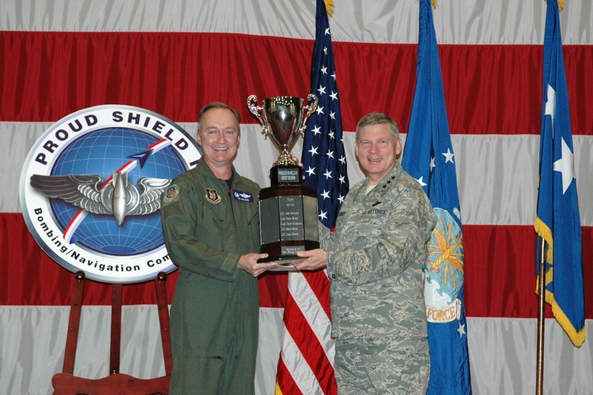 Col. Edmund D. Walker, commander, 917th Wing, Barksdale Air Force Base, LA., accepts the Proud Shield II Best Bomb award on behalf of the winning B-52 crew from Lt. Gen. Robert J. Elder Jr., commander, 8th Air Force, Barksdale AFB, LA., during the Giant Sword II/Proud Shield II Bomb and Load Competition and Symposium awards ceremony March 4, 2009 at Hoban Hall at Barksdale. The winning crew consisted of Capt. Andrew Baird, aircraft commander, Lt. Col. Jeff Stogsdill co-pilot, Capt. Andrew Marshall, radar navigator, Lt. Col. Steve Smith, navigator and Lt. Col. John Dorsey electronic warfare officer. (US Air Force photo/Tech. Sgt. Jeff Walston)