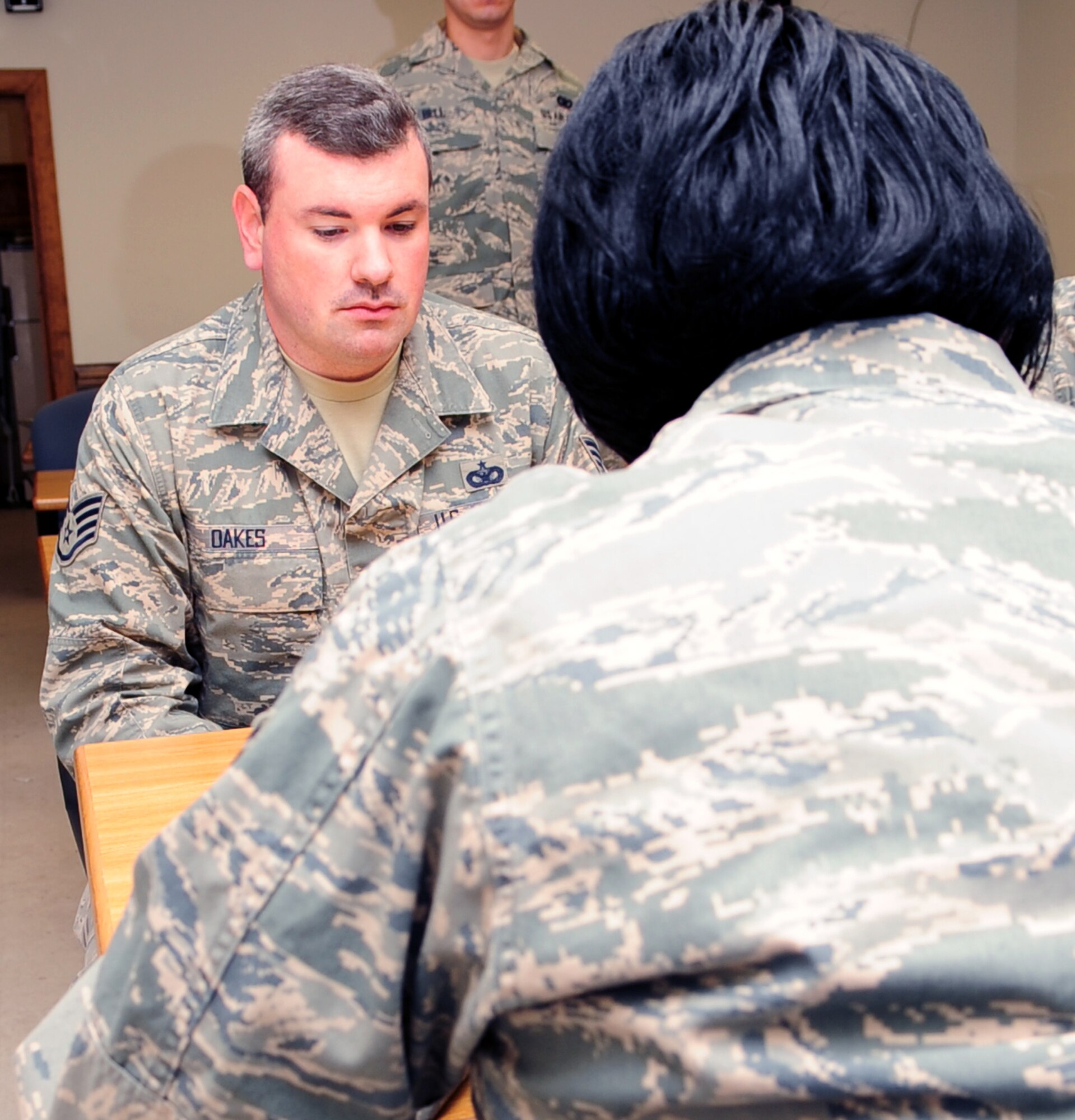 Staff Sergeant Jonathan Oaks, 4th Security Forces Squadron, out-processes with Staff Sergeant Twanda Smith, 4th Military Personnel Element, at Seymour Johnson Air Force Base, N.C. This will be Sergeant Oaks' sixth deployment while being stationed here. (U.S. Air Force Photo by Airman 1st Class Rae A. Perry)
