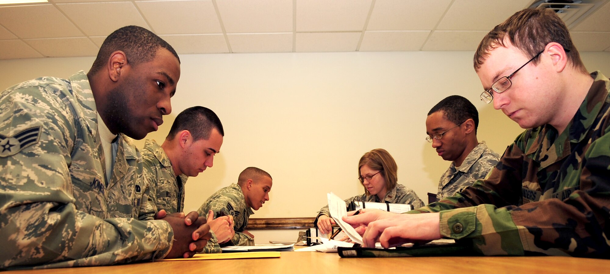 Members of the 4th Military Personnel Element assist members of the 4th Security Forces Squadron out-process for their upcoming deployment from Seymour Johnson Air Force Base, N.C. For many of the Airmen, this is not their first deployment. (U.S. Air Force Photo by Airman 1st Class Rae A. Perry) 
