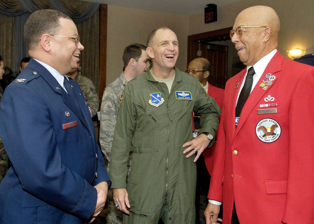 Col Taro Jones, 113th commander's assistant for Force Development , and Maj Gen Ralph Jodice, Air Force District of Washington commander, socialize with Byron Morris, president of the East Coast Chapter of the Tuskeegee Airmen on Feb 27 at the club. The recognition ceremony included social hour, a guest speaker, and presentations honoring the Tuskeegee Airmen. (US Air Force photo/Senior Airman Renae Kleckner)