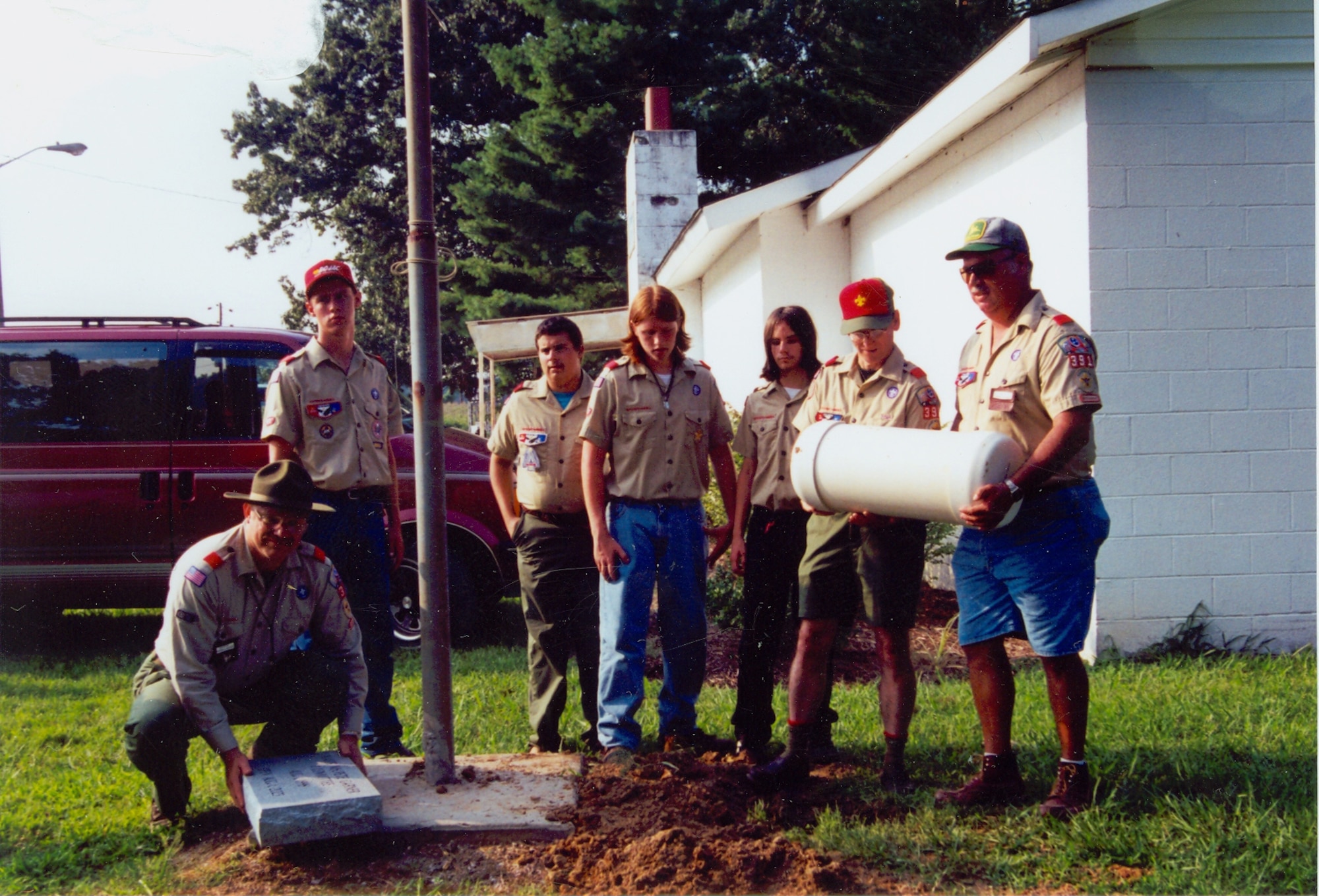 Left, Arnold Engineering Development Center’s Bob Weiten, the Scout Master for Estill Springs Boy Scout Troop 391, holds the marble stone that will mark the location of a time capsule buried outside the ‘Scout Hut’ in Estill Springs in 1997. From left, Daniel Glascoe, Nicholas Weiten, Zachary Peters, William Peters and Danny Glascoe also took part in the event. (Photo provided)