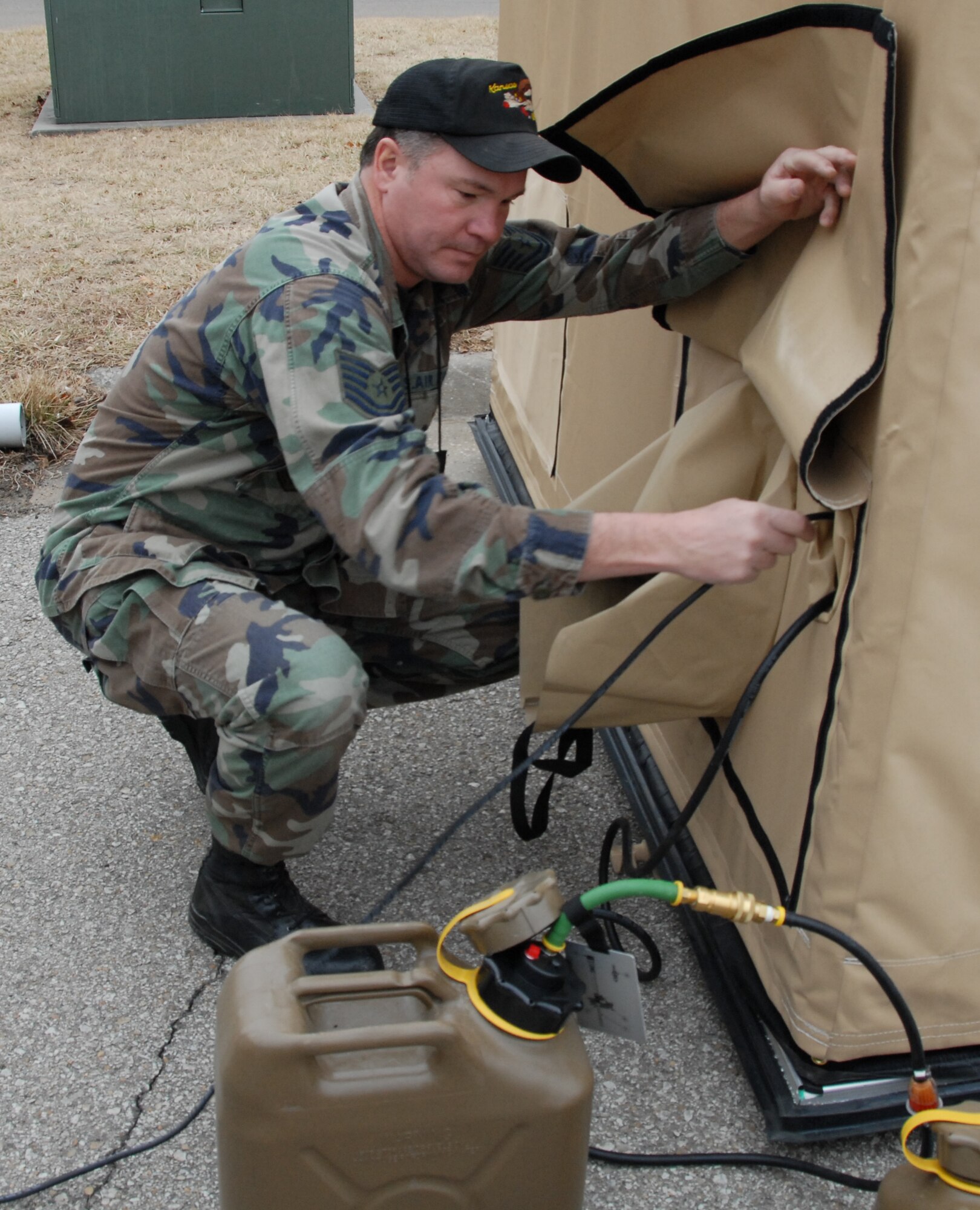 Tech. Sgt. Travis Schuler runs electicity to the SPEK prior to meal preparation. (Photo by Senior Airman Jake Meyer)