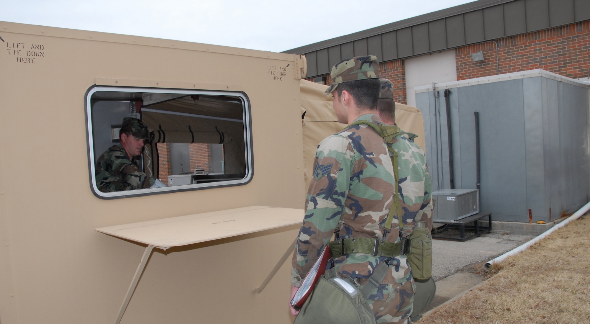 Tech. Sgt. Sean Cochran serves lunch to “deployers” from the new Single Pallet Expeditionary Kitchen, or SPEK, during the February UTA.b (Photo by Staff Sgt. Emily Alley)