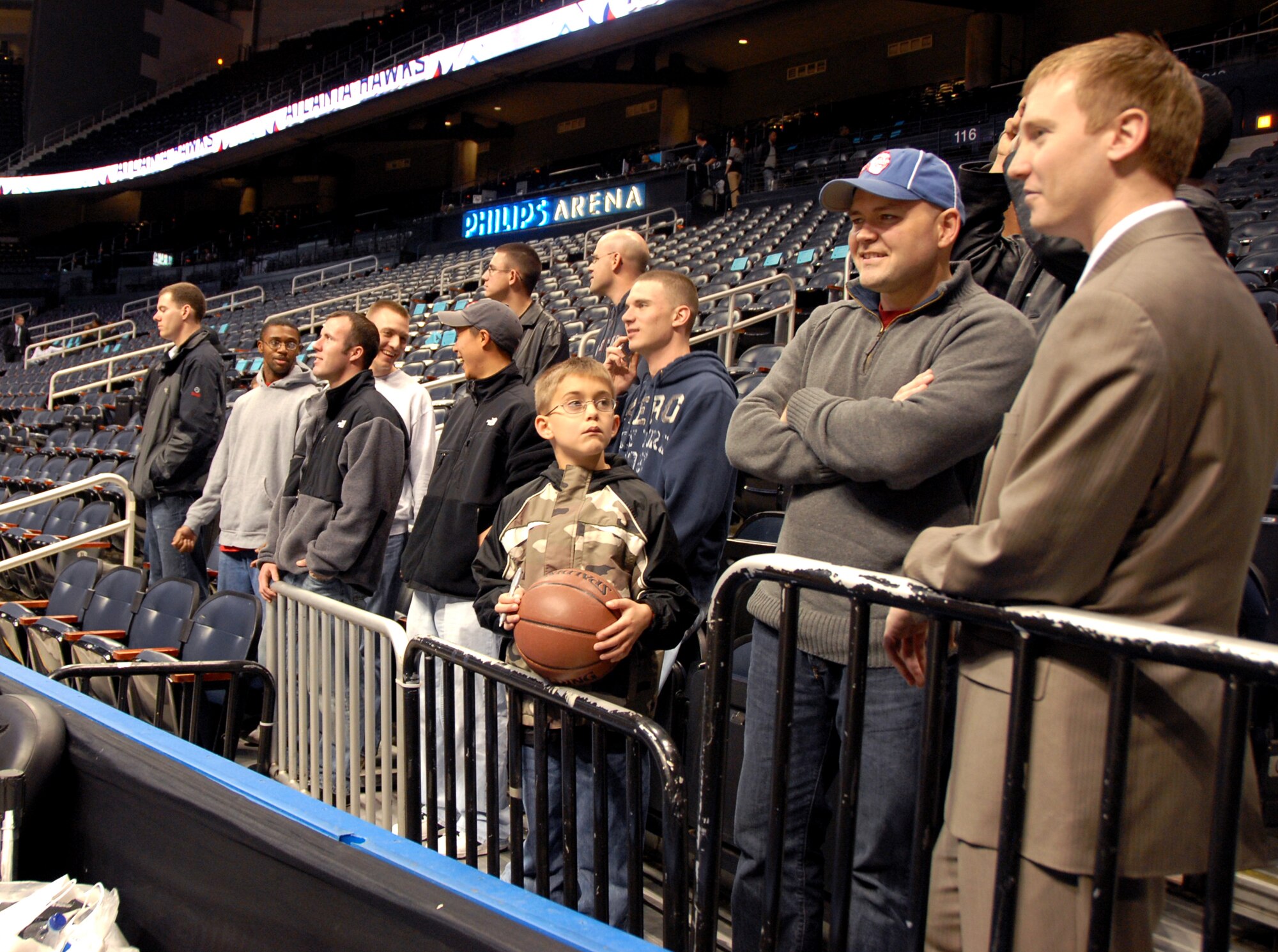 Mitch Ried, Atlanta Hawks representative, (right) talks with Chaplain (Capt.) Joshua Payne as members of the Airmen Leadership Program watch the Hawks shoot around prior to the Hawks game against the Cleveland Cavaliers Sunday. U. S. Air For5ce photo by Wayne Crenshaw