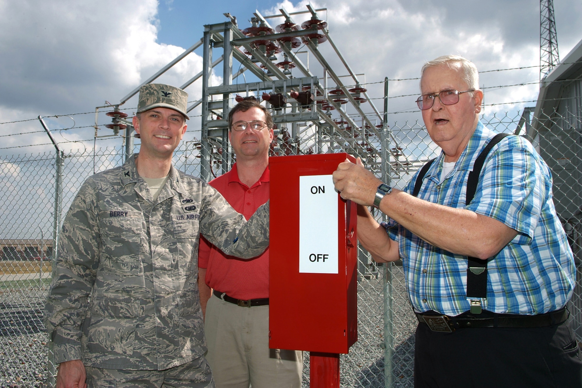 Col. Warren Berry, 78th Air Base Wing commander, Jim Holten, Georgia Power project manager, and William Fowler, former infrastructure support chief, flip the ceremonial switch to activate the substation Feb. 26. U. S. Air Force photo by Gary Cutrell