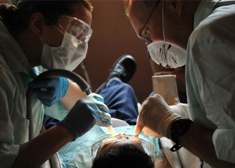 Sgt. Odessa Torrez assists Col. Michael Jung as he performs a dental filling on a Honduran girl durning a dental readiness training excercise at the Lions Club in Comayagua, Honduras, Feb. 24. The DENTRETE is a part of Beyond the Horizons, a humanitarian assistance exercise taking place throughout Central America. (U.S. Army photo by Spc. Christopher Wellner)