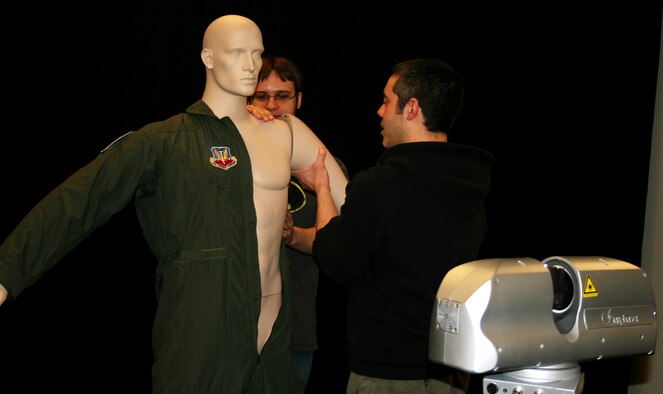 Brenton Mathews and David Pent, employees of Activision subsidiary Raven Software, assemble a mannequin wearing a flight suit belonging to the 115th Fighter Wing. The figure was scanned in 3-D for a representative sample of authentic flight suits for use in current and possible future video games. (U.S. Air Force photo by Staff Sgt. Jon LaDue)  