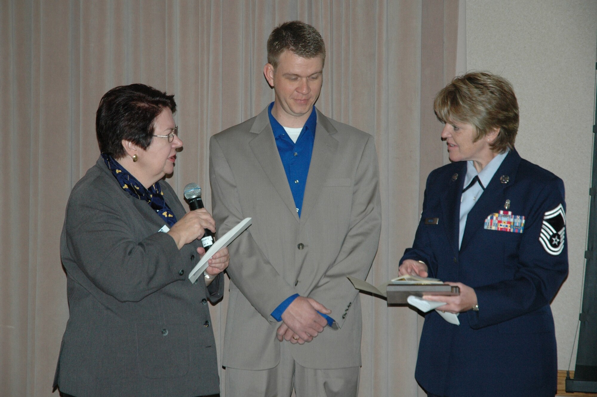 Lt. Col. (ret.) Mary Jane Dundas, Tempe Military Affairs Committee chair, presents Senior Master Sgt. Cheryl Wente, 944th Medical Squadron health service manager, the Graydon Williams Award plaque during a luncheon Feb. 18.  Kelley Williams, son of the late Tech. Sgt. Graydon Williams, was a special guest during this year's luncheon.  The award is presented annually to an Air Reserve Technician or Active Guard Reserve member who personifies the character and traits of the late Tech. Sgt. Graydon Williams, a 944th Maintenance Group member who died at a young age of cancer.  The essence of the award is based on superior performers who do not seek recognition, perform clearly above expectations, and have not been adequately recognized for their overall contributions and impact on the wing.  (U.S. Air Force photo/Tech. Sgt. Susan Stout)