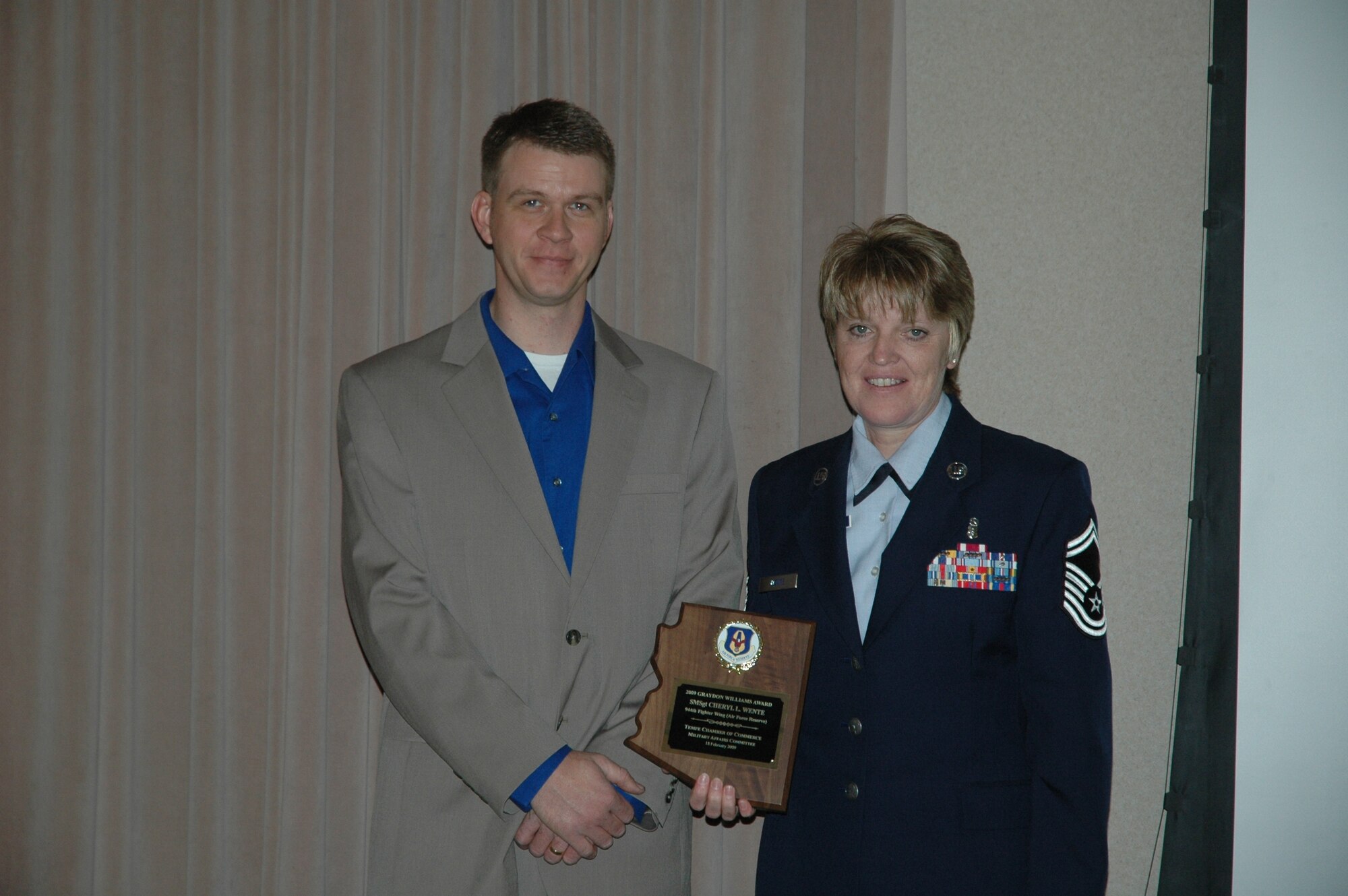 Senior Master Sgt. Cheryl Wente, 944th Medical Squadron health service manager, poses with Kelley Williams after receiving the Graydon Williams Award during a luncheon Feb. 18.  The award is presented annually to an Air Reserve Technician or Active Guard Reserve member who personifies the character and traits of the late Tech. Sgt. Graydon Williams, a 944th FW maintenance ART who died at a young age of cancer.  The essence of the award is based on superior performers who do not seek recognition, perform clearly above expectations, and have not been adequately recognized for their overall contributions and impact on the wing.  (U.S. Air Force photo/Tech. Sgt. Susan Stout)
