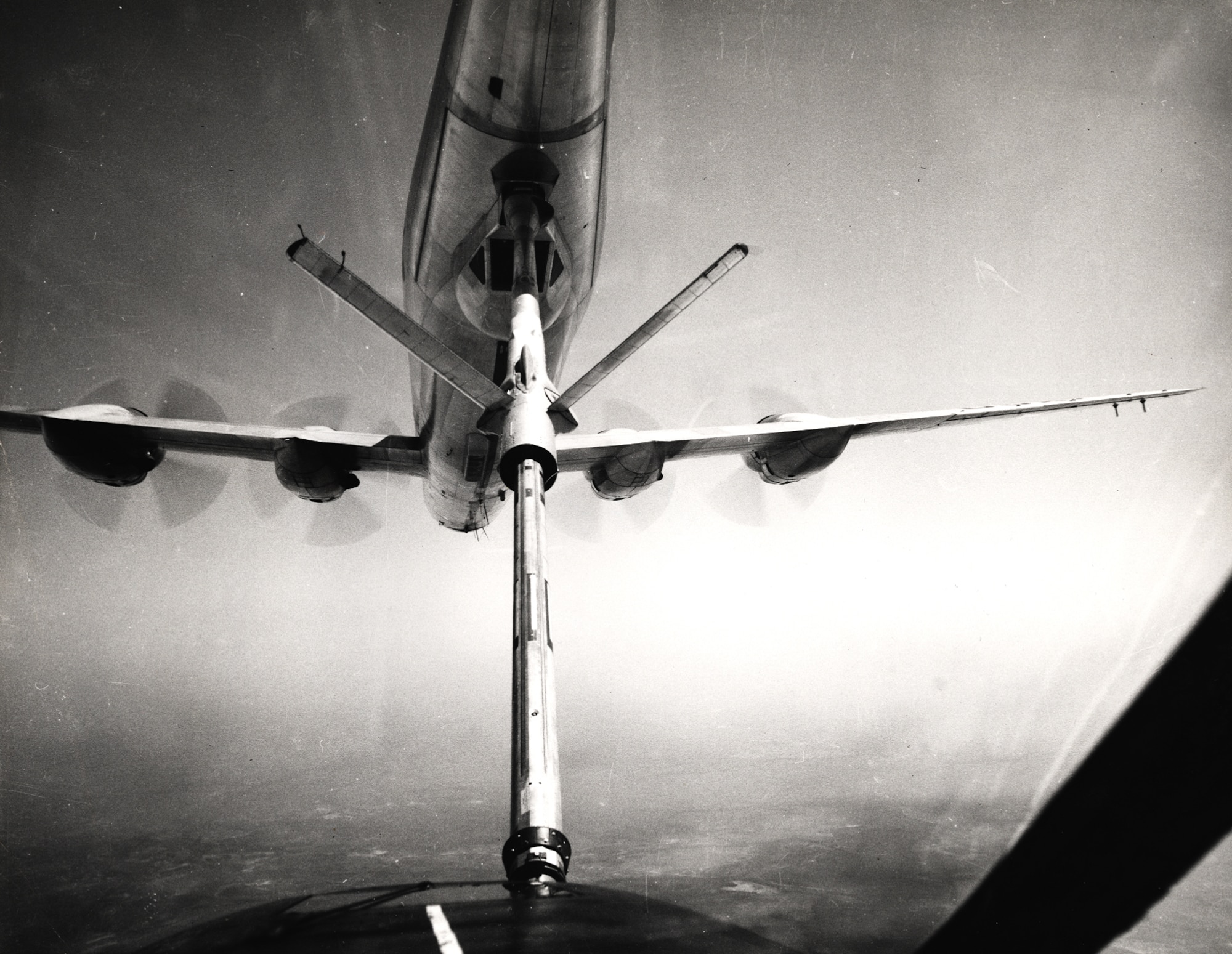 This pilot?s-eye view of an inflight refueling operation provides an excellent view of the flying boom and the boomer pod on the underside of the KC-97 (U.S. Air Force photo)