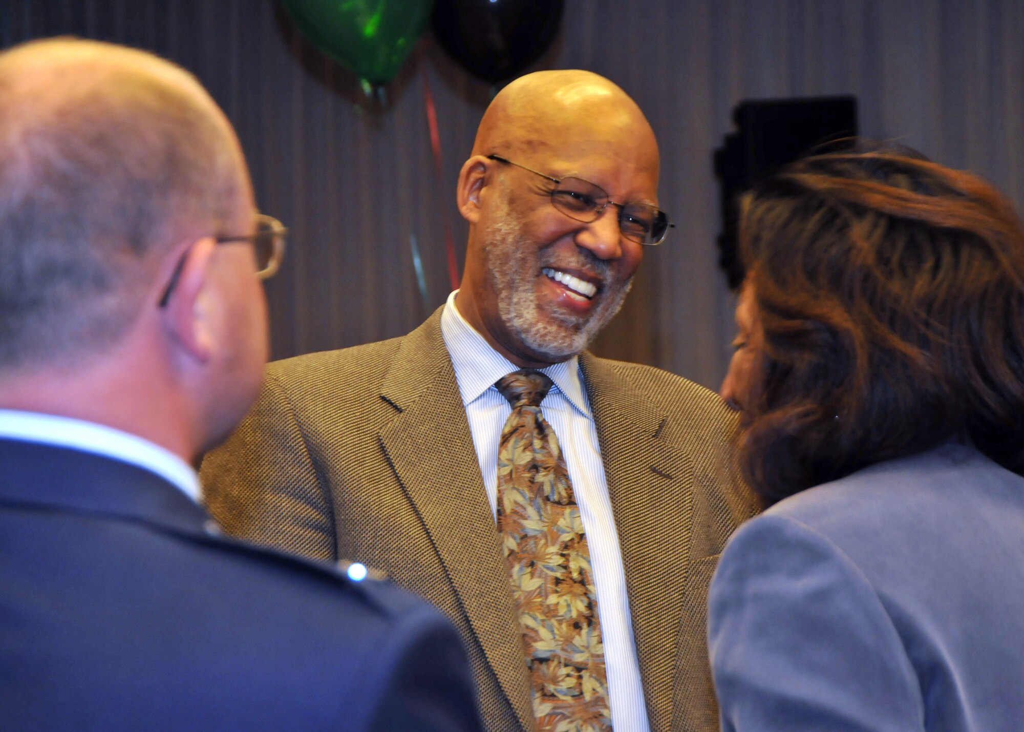 Dr. Terrence Roberts (center), a member of the Little Rock Nine, greets the audience members during the Black History month luncheon hosted jointly by SMC and The Aerospace Corporation, Feb. 19. Dr. Roberts spoke of his experiences as one of the nine students who attended Central High School in Little Rock, Ark. and of his perspectives on integration in the United States. (Photo by Atiba S. Copeland)