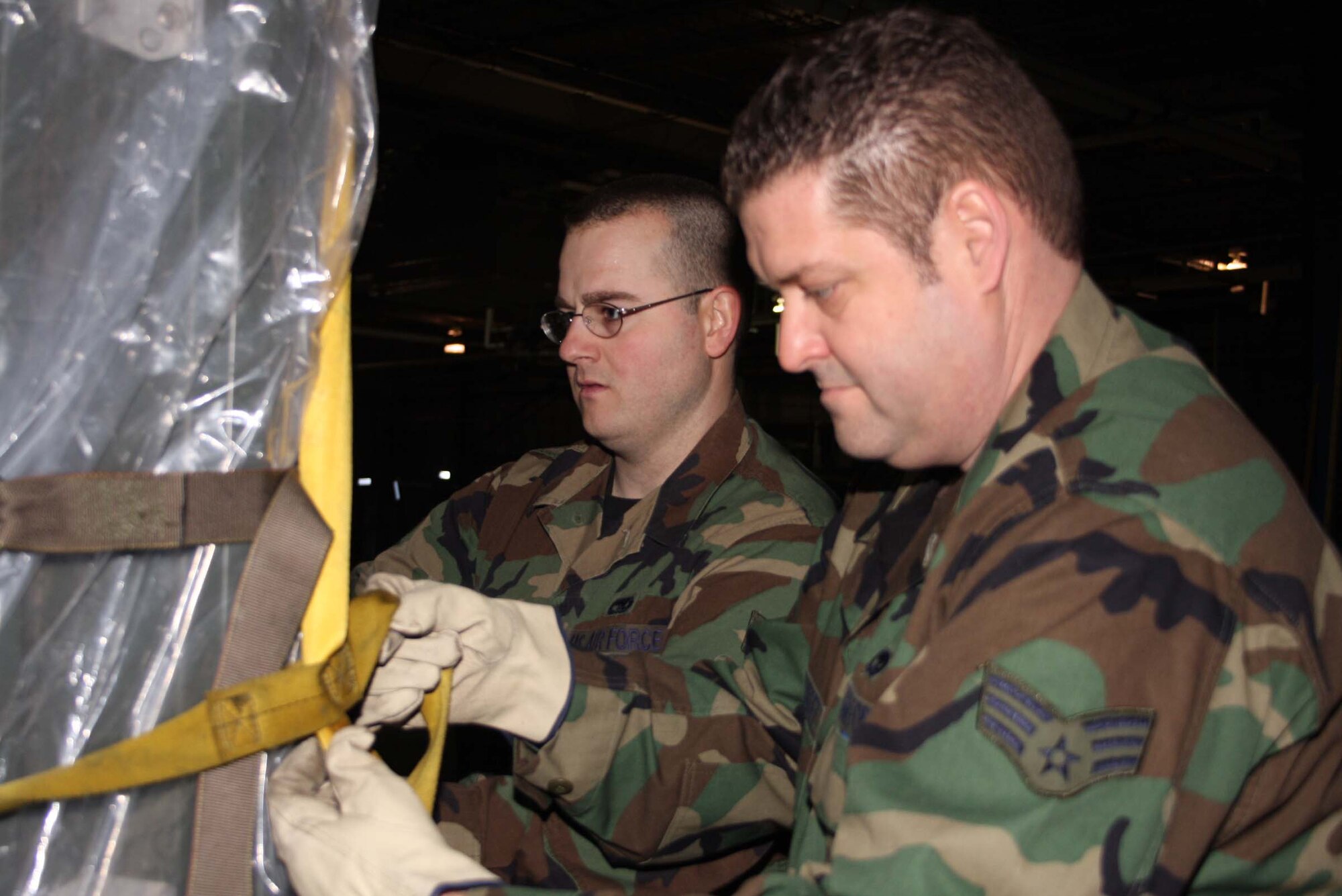 WRIGHT-PATTERSON AFB, Ohio – Senior Airman David Jones, left, and Senior Airman Russ Hernandez, both from the 87th Aerial Port Squadron, are participating in a pallet building training exercise in preparation of the unit’s spring deployment.   (Air Force photo/Senior Airman Ken LaRock) 