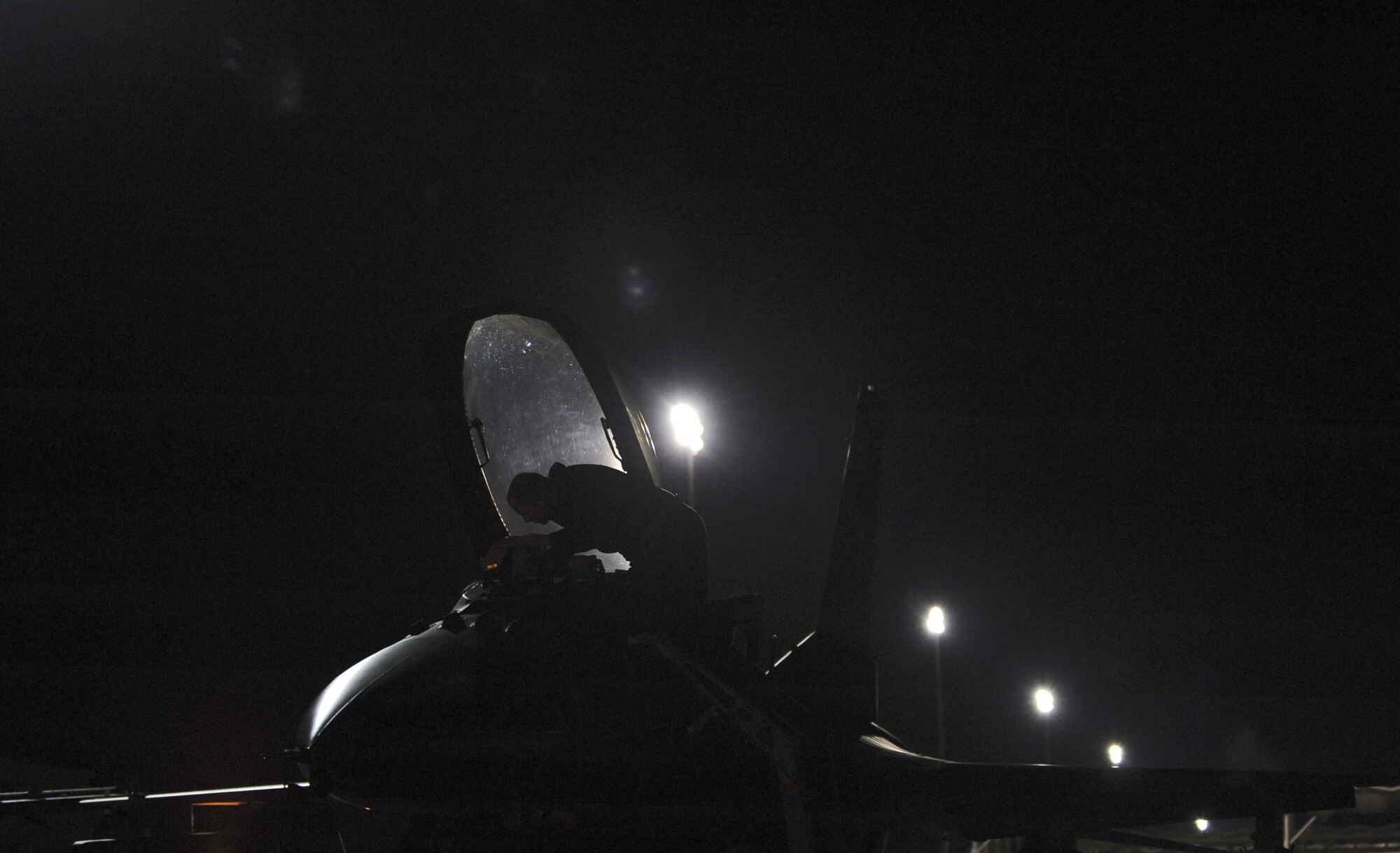 Airman 1st Class Patrick Densford inspects the cockpit of an F-16 Fighting Falcon before night flying operations during Red Flag 09-3 Feb. 26 at Nellis Air Force Base, Nev. Red Flag is a multinational exercise providing a realistic environment to practice combat scenarios. Airman Densford is a 52nd Aircraft Maintenance Squadron F-16 crew chief deployed from Spangdahlem Air Base, Germany. (U.S. Air Force photo/Senior Airman Larry E. Reid Jr.) 
