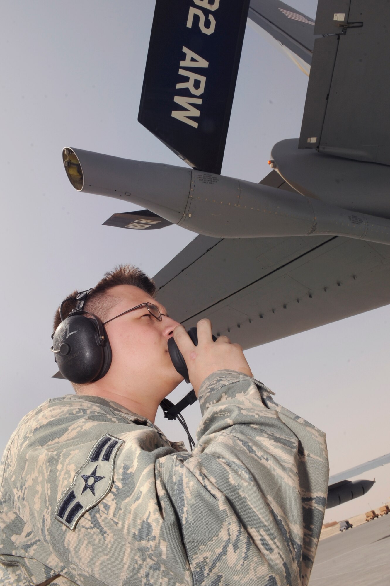 Airman 1st Class Justin Simpson, a crew chief with the 379th Expeditionary Aircraft Maintenance Squadron, talks with the pilot of a KC-135R Stratotanker as he confirms proper operation of the control surfaces during preflight checks, March 5, 2009, in an undisclosed location in Southwest Asia.  Airman Simpson and the pilot communicate via headsets letting each other know if there are any problems with the aircraft during the checks.  Airman Simpson hails from College Station, Texas and is deployed from McConnell Air Force Base, Kan. in support of Operations Iraqi and Enduring Freedom and Combined Joint Task Force - Horn of Africa.  (U.S. Air Force Photo by Staff Sgt. Joshua Garcia/released)
